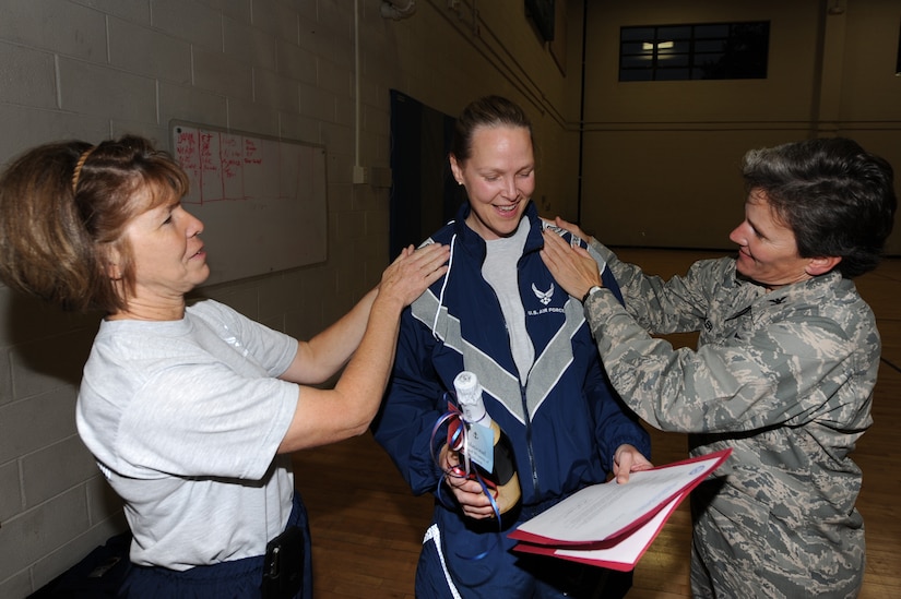 U.S. Air Force Col. Martha Meeker, right, and Col. Consuella Pockett, left, pin colonel rank on Lt. Col. Pamela Smith after she was notified of her selection for promotion to colonel at the Fitness and Sports Center Nov. 16, 2010, on Joint Base Charleston, S.C. Colonel Smith was one of two colonel selectees from JB CHS. Lt. Col. Bonnie Goodale, 628th Medical Support Squadron commander, was also selected for promotion to colonel. Colonel Meeker is the JB CHS commander and Colonel Pockett is the 628th Medical Group commander. Colonel Smith is the 628th Aerospace Medicine Squadron commander. (U.S. Air Force photo/Tech. Sgt. Chrissy Best)