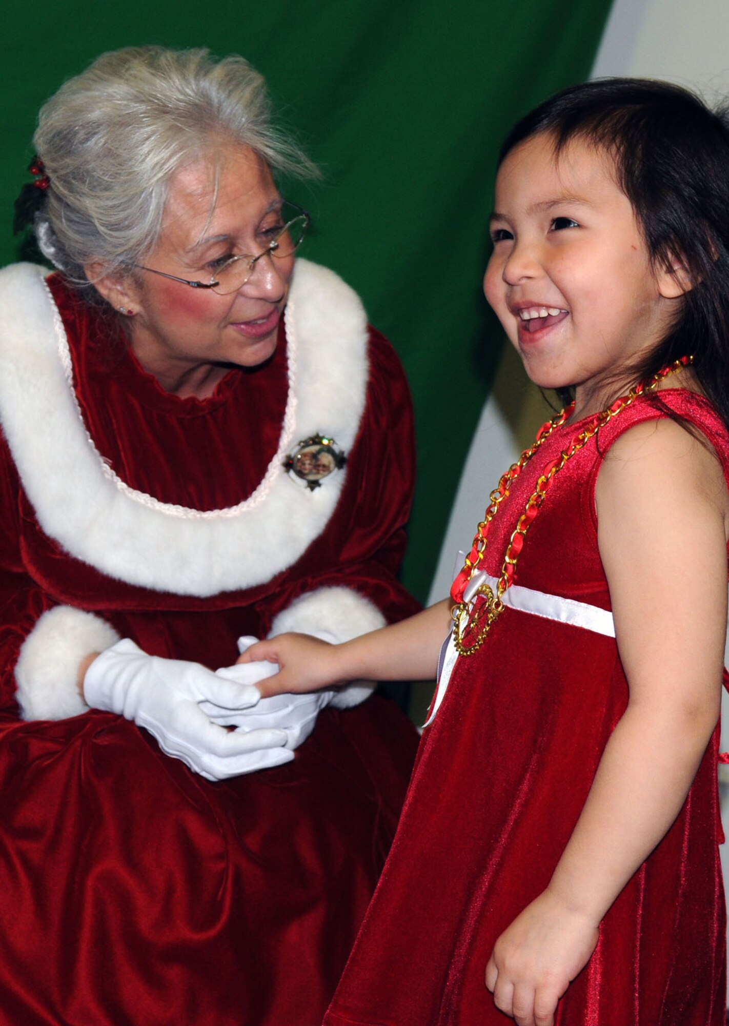 Mrs. Claus greets 3-year-old Glael Rukovishnikof, a resident of St. Paul, during Operation Santa Claus Nov. 6. (Alaska Army National Guard photo/Pfc. Karina Paraoan)