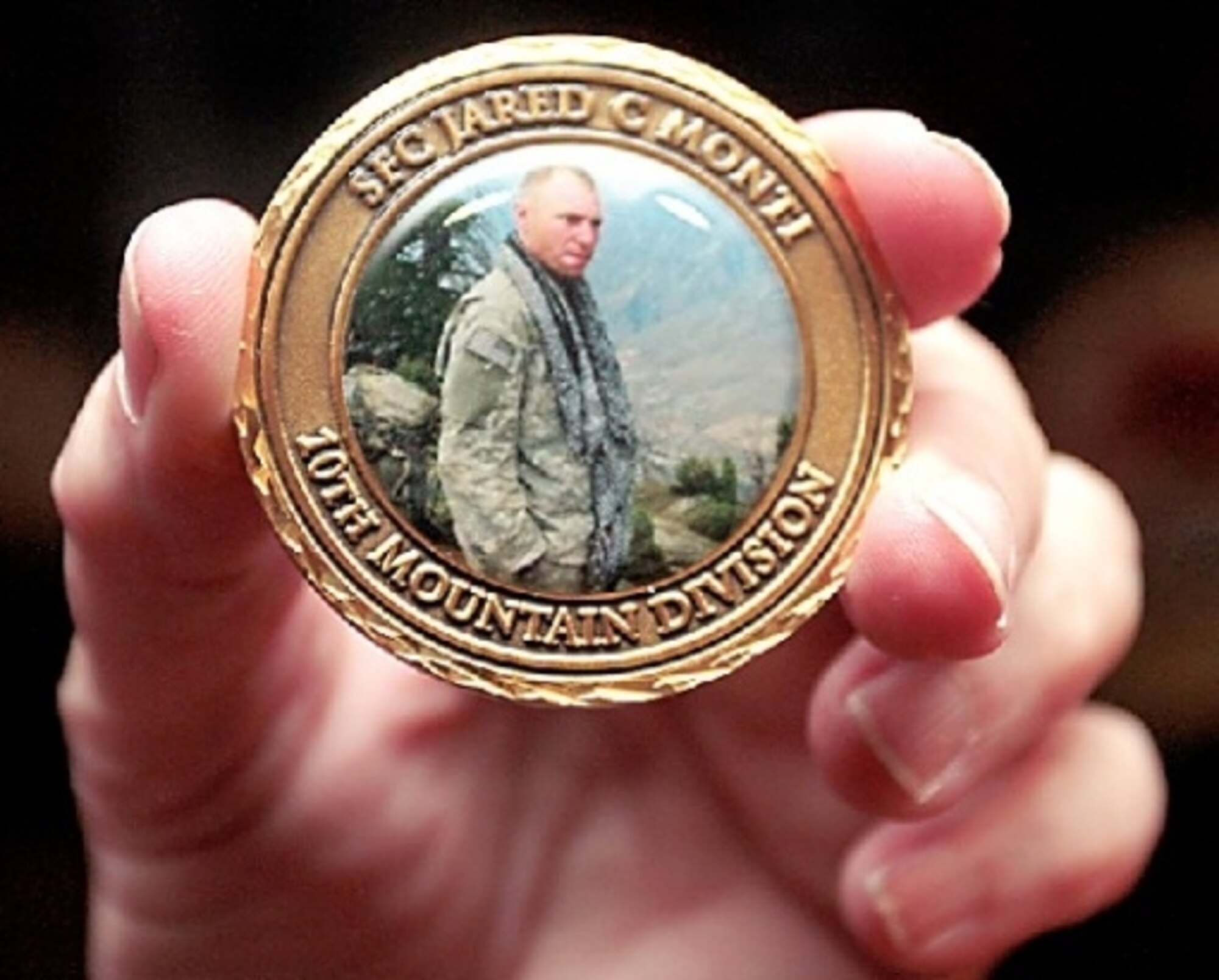 Army Staff Sgt. Jared Monti's likeness is displayed on a coin that was presented to Col. Patrick Doherty by Sergeant Monti's mother, Janet Monti. Sergeant Monti was killed in Afghanistan while attempting to save a wounded soldier. Colonel Doherty is the 4th Fighter Wing commander. (Courtesy photo/News-Argus/Michael K. Dakota)