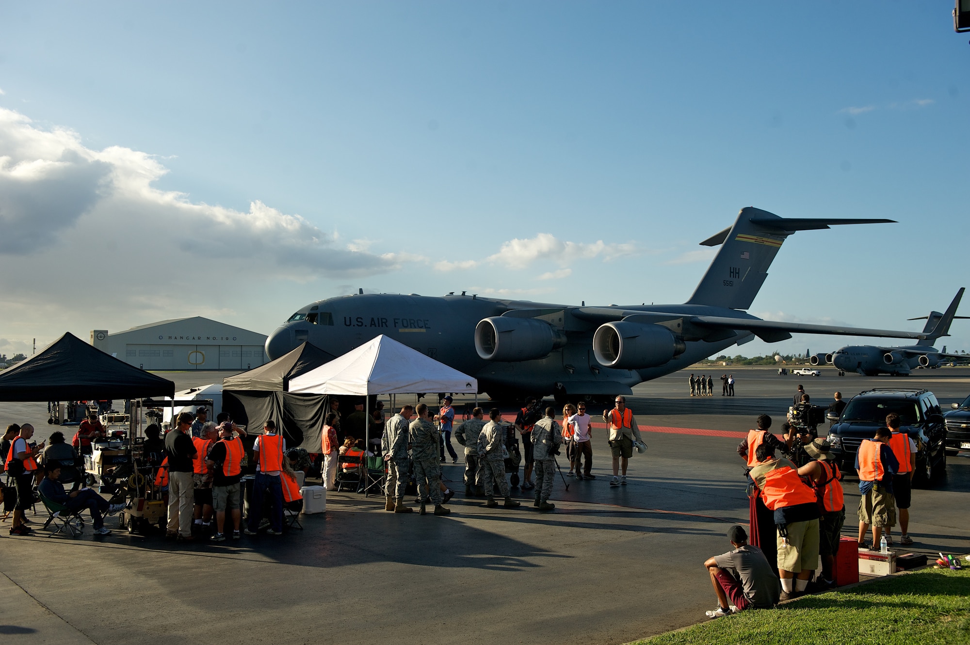 The Hawaii Five-0 production crew uses a C-17 Globemaster III from the 15th Wing as a backdrop while filming a scene on Oct. 11. The cast and crew of the hit show are on Joint Base Pearl Harbor-Hickam filming for a recent episode. (U.S. Air Force Photo/Master Sgt. Jeffrey Allen)
