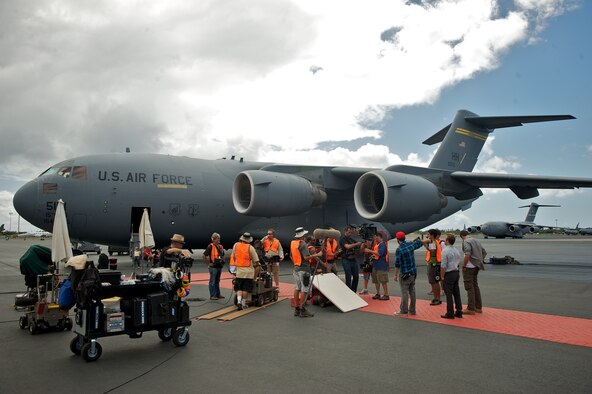The Hawaii Five-0 production crew uses a C-17 Globemaster III from the 15th Wing as a backdrop while filming a scene on Oct. 11. The cast and crew of the hit show are on Joint Base Pearl Harbor Hickam filming for an episode. (U.S. Air Force Photo/Master Sgt. Jeffrey Allen) 