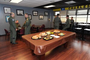 Airmen socialize in the newly renovated Heritage Room at the 17th Airlift Squadron on Joint Base Charleston-Air Base, S.C., Nov. 16, 2010. Planning for the project began in July, with work beginning in August. A group of approximately 10 squadron volunteers stepped up to take on the work of transforming the room. Starting with baring the walls, the team removed old carpeting, applied fresh paint and installed new wood flooring.  (U.S. Air Force phot/James Bowman)