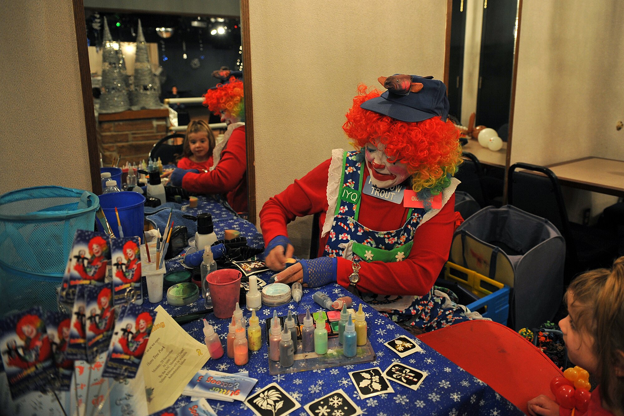 OFFUTT AIR FORCE BASE, Neb. -- (From Left) Donna Trout, also known as Rainbow Trout the clown, gets ready to paint the face of Kami Cole, step daughter of Capt. Howard Moore, during holiday connections in the Community Center here Nov. 16. More than 100 Team Offutt families attended and made gifts, cards and video messages for their loved ones who will be away from home this holiday season. The annual event, established in 2000, provides a fun environment  for families to come together and share a little joy.
U.S. Air Force Photo by Charles Haymond
