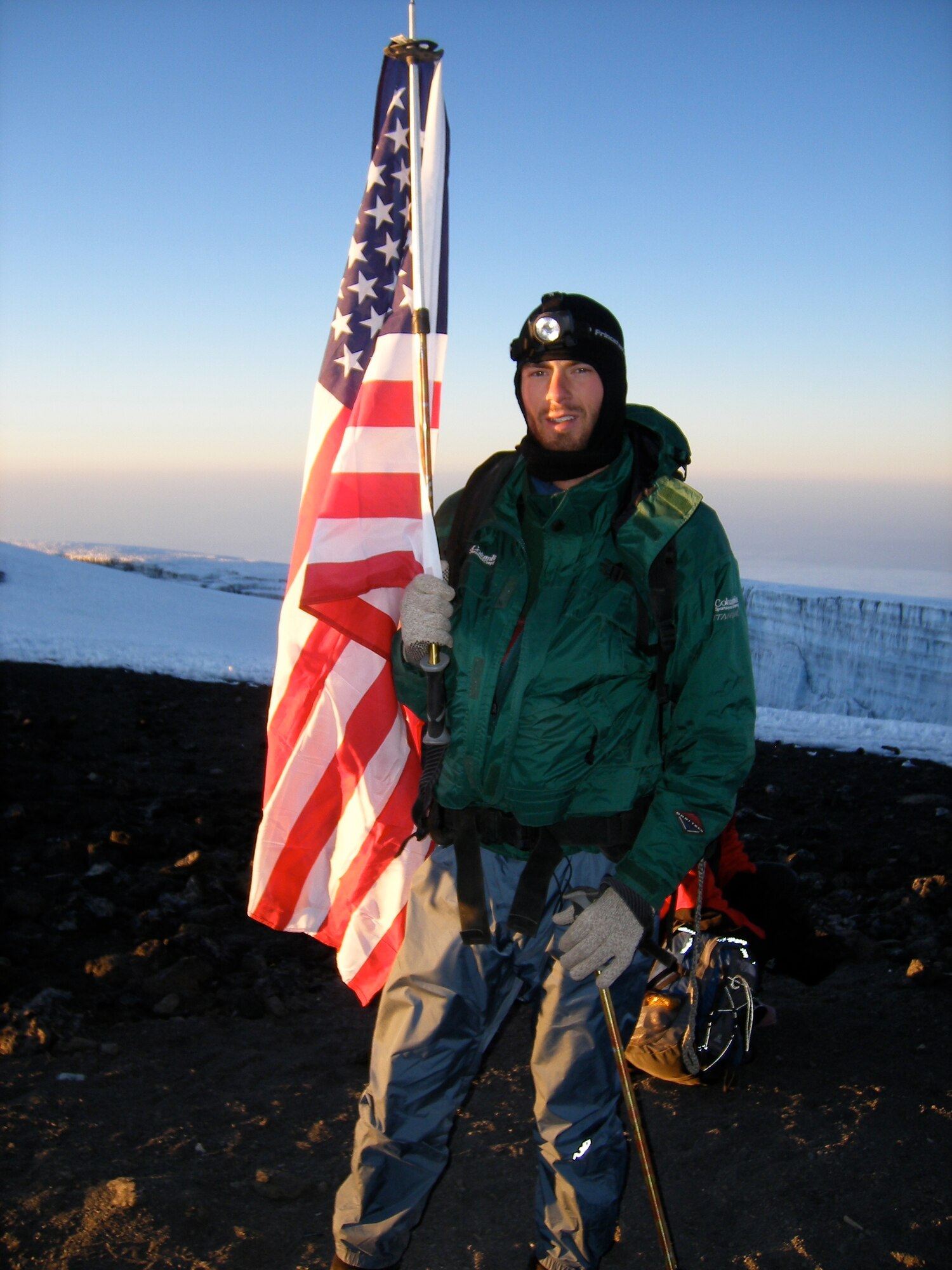 Capt. Graydon Muller, a member of the 6th Special Operations Squadron, poses at the summit of Mt. Kilimanjaro, the highest peak in Africa, as part of the U.S. Air Force Seven Summits Challenge in July 2006. The U.S. Air Force Seven Summits Challenge is an endeavor for Air Force members to carry the Air Force flag to the highest point on each continent and to be the first U.S. military group to conquer all seven peaks. Captain Muller and Capt. Rob Marshall, a member of the 8th Special Operations Squadron, will depart Nov. 24, 2010 to attempt the group's fifth summit, Vinson Massif in Antarctica.  The Airmen say Air Force Special Operations Command is uniquely equipped to prepare them to be successful in Antarctica's austere environment. (Courtesy Photo/Released)