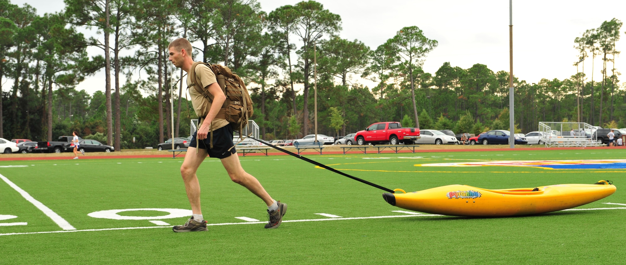 U.S. Air Force Capt. Graydon Muller, 6th Special Operations Squadron, pulls a kayak across the Aderholt Fitness Center field at Hurlburt Field, Fla. Oct. 28, 2010 to simulate pulling a supply sled in preparation for an upcoming mountaineering expedition to climb Vinson Massif, the highest mountain in Antarctica. Captain Muller and Capt. Rob Marshall, 8th Special Operations Squadron, depart Nov. 24, 2010 to climb the 16,076 foot mountain as part of the U.S. Air Force Seven Summits Challenge, an effort for Air Force members to climb the highest mountain on each continent. (U.S. Air Force photo by Staff. Sgt. Stephanie Jacobs/RELEASED)