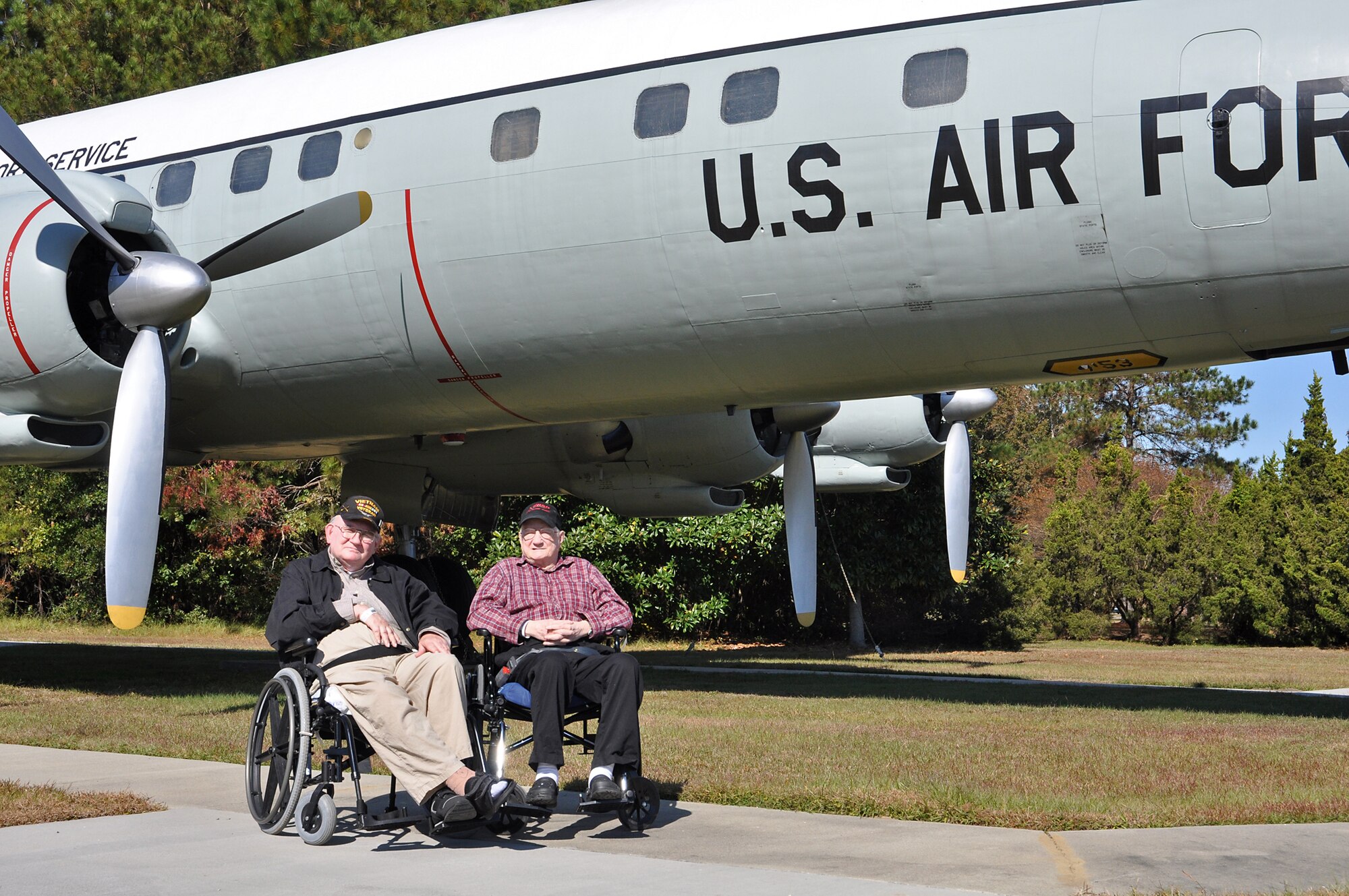 Veterans and Community living center residents Leonard Whitaker and Richard Cammer from Ralph H. Johnson VA Medical Center pose for photos in front of a historic C-121 at Joint Base Charleston. The Veterans toured the base Nov. 15 as part of the 315th Airlift Wing’s community relations program. (U.S. Air Force Photo/Michael Dukes)