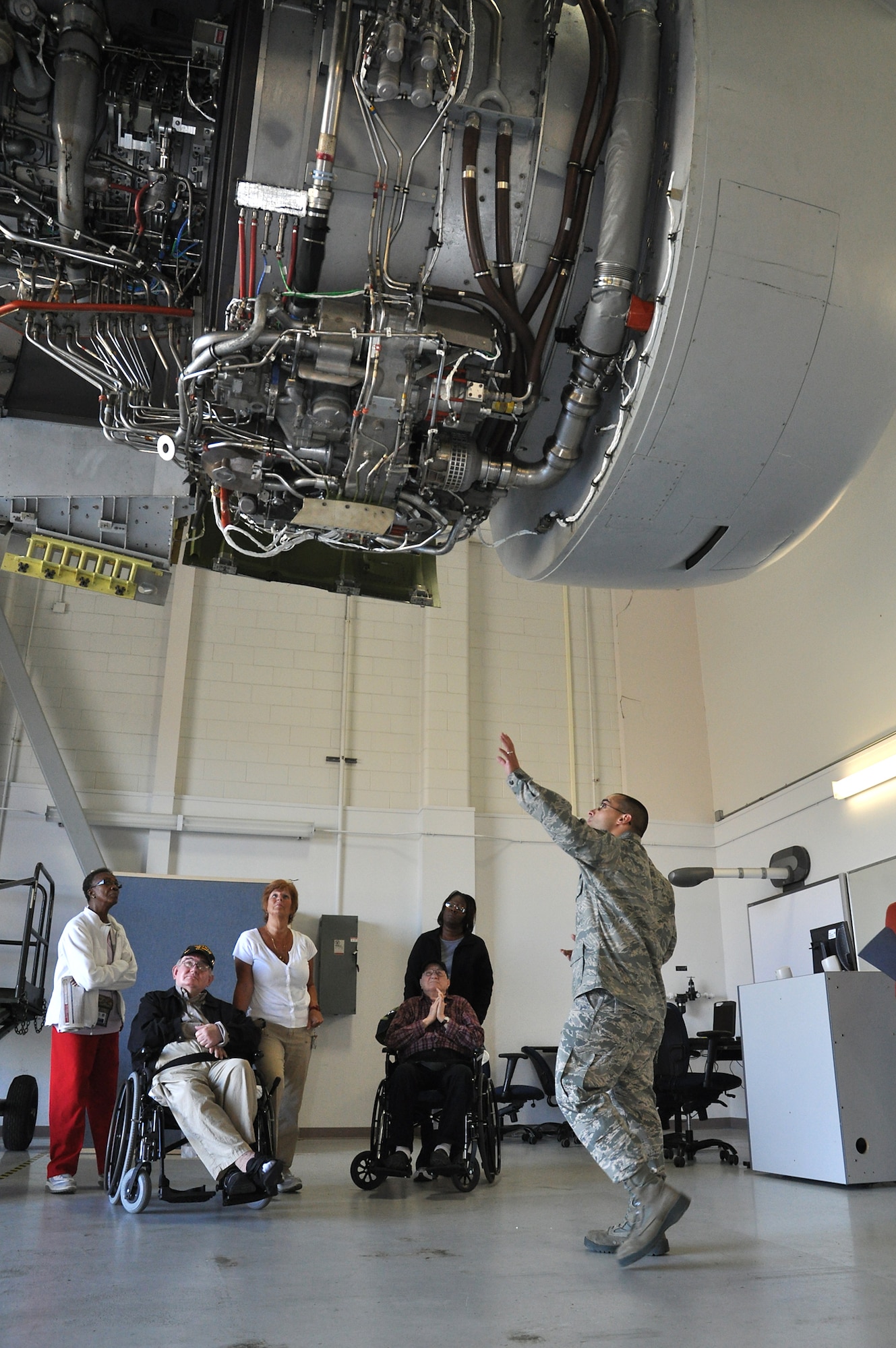 Staff Sgt. Reloit Rodriguez, Air Education Training Command 373rd Training Squadron Detachment  5, explains some of the safety features of the C-17 engine to veterans Leonard Whitaker and Richard Cammer . The Veterans, who are residents of the community living center at Ralph H. Johnson VA Medical Center toured the Joint Base Charleston Nov. 15 as part of the 315th Airlift Wing’s community relations program (U.S. Air Force Photo/Michael Dukes)