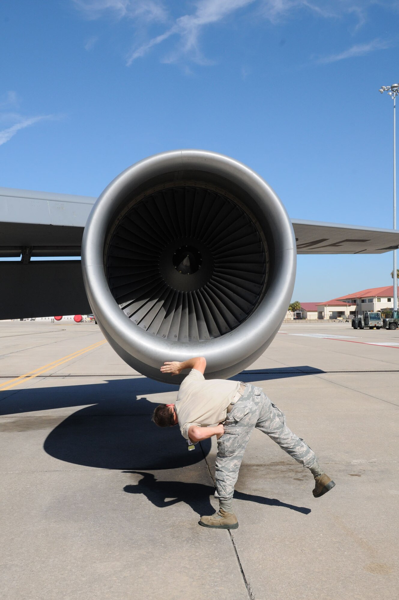 MacDill Air Force Base, Fla. --  Senior Airman Kyle Steady, a crew chief with the 927th Air Refueling Wing, braves the afternoon sun here to make sure there were no leaks around the engine of a KC-135 tanker aircraft. Steady participated in a recent operational readiness exercise that required the unit to deploy airplane tankers to refuel tactical aircraft on short notice.  Steady has the responsibility of making sure the plane was flight-ready at all times. (Official United States Air Force photo by Staff Sgt. Shawn C. Rhodes)