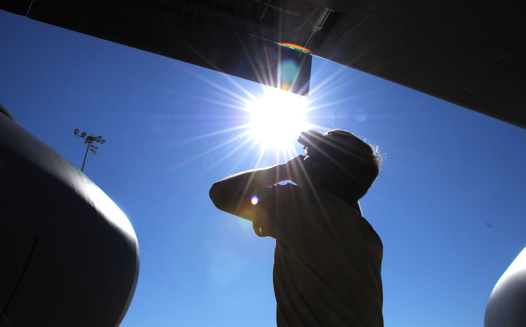 MacDill Air Force Base, Fla. --  Senior Airman Kyle Steady, a crew chief with the 927th Air Refueling Wing, braves the afternoon sun here to make sure there were no leaks around the wings of a KC-135 tanker aircraft. Steady participated in a recent operational readiness exercise that required the unit to deploy airplane tankers to refuel tactical aircraft on short notice.  Steady has the responsibility of making sure the plane was flight-ready at all times. (Official United States Air Force photo by Staff Sgt. Shawn C. Rhodes)