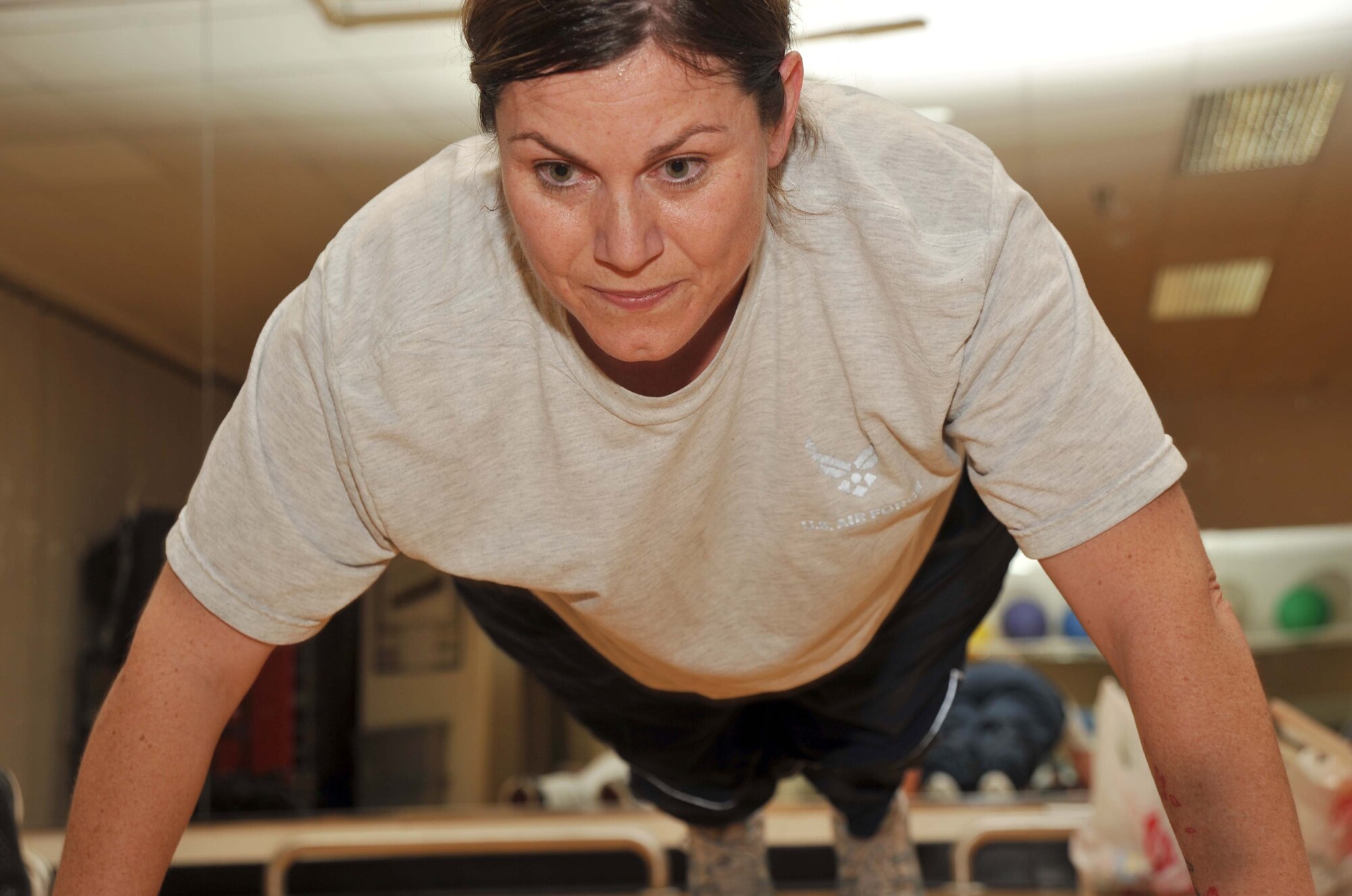Staff Sgt. Stacey Clouse, 22nd Medical Support Squadron Customer Service/PV/Acquisitions NCOIC, performs a pushup as part of the 22nd Medical Group’s physical fitness training Nov. 15, 2010, McConnell Air Force Base, Kan.  Sergeant Clouse recently improved her PT score from a 70.8 to a 90.2.  (U.S. Air Force photo/Senior Airman Abigail Klein)