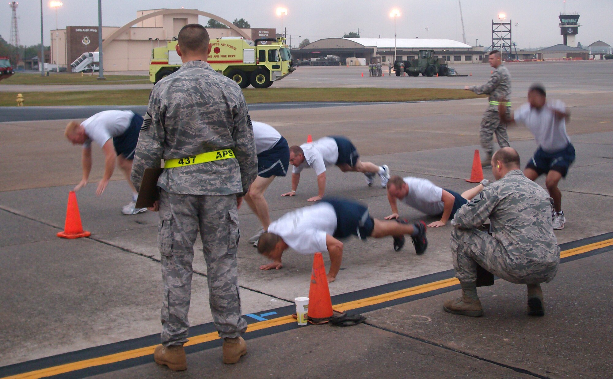 Aerial porters from the 39th Aerial Port Squadron (background) give it their all during a physical training competition Oct. 28 at Dobbins Air Reserve Base, Ga. The AF Reservists represented the 39th APS Oct. 25-29 during the inaugural Air Force Reserve Command Port Dawg Challenge. The event brought together 23 aerial port squadrons in a number of friendly competitions, testing Reservists' speed and accuracy in a variety of aerial port challenges common to the career field. The 39th APS took first place in the timed forklift driving course, while the overall Port Dawg Challenge winners were the 27th APS from Minneapolis-St. Paul Air Reserve Station, Minn. The 39th APS is a subordinate organization to the Colorado-based 302nd Airlift Wing. (U.S. Air Force photo/Lt. Col. Michael Burns)