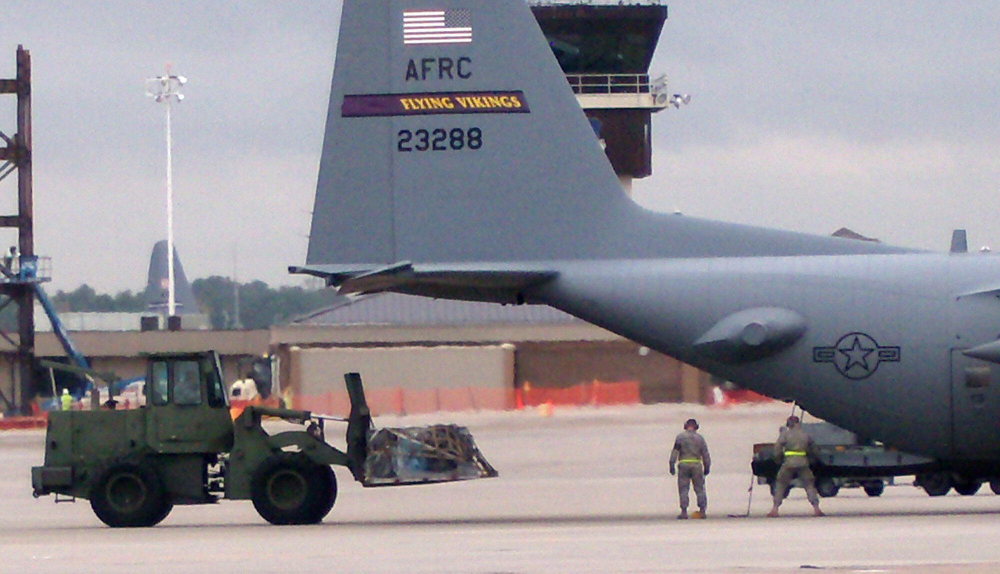 Air Force Reserve aerial porters Tech. Sgt. Shane Goddard and Airman 1st Class Chris Meyer (right) ensure forklift driver Tech. Sgt. Justin Baker has enough clearance to load cargo onto an awaiting C-130 Hercules during an engine running on-load competition Oct. 26 at Dobbins Air Reserve Base, Ga. Each AF Reservist represented the 39th Aerial Port Squadron Oct. 25-29 during the inaugural Air Force Reserve Command Port Dawg Challenge. The event brought together 23 aerial port squadrons in a number of friendly competitions, testing Reservists' speed and accuracy in a variety of aerial port challenges common to the career field. The 39th APS took first place in the timed forklift driving course, while the overall Port Dawg Challenge winners were the 27th APS from Minneapolis-St. Paul Air Reserve Station, Minn. The 39th APS is a subordinate organization to the Colorado-based 302nd Airlift Wing. (U.S. Air Force photo/Lt. Col. Michael Burns)