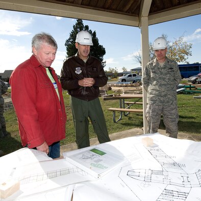 (from left) Doug Hanauer, Leather and Associates construction consultant, Gen. Raymond Johns, Air Mobility Command commander and Col. Manson Morris,436th Airlift Wing commander, look at the blue prints for Liberty Park, a new playground area being built next to the base swimming pool at Dover AFB, De., Nov. 6, 2010. Wing leadership directed a portion of funds obtained from winning the 2010 Air Mobility Command's Commander-in-Chief's Award for Installation Excellence for the park’s construction.  The playground, designed by Leathers and Associates, features swings, slides and other play areas contained inside a huge shell resembling a large cargo military aircraft. It could be a C-17 or a C-5, depending on how you look at it. The park is being built by more than 900 base volunteers. (U.S. Air Force Photo/Jason Minto)