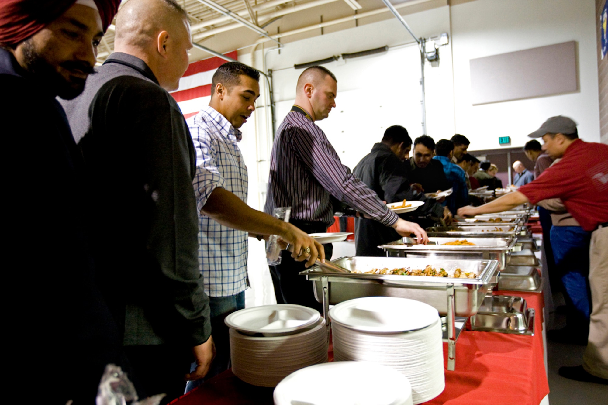 JOINT BASE ELMENDORF-RICHARDSON, Alaska - U.S. and Indian Army soldiers attack the main line where Indian and American cuisines ranging from curried chicken skewers to Alaskan salmon were served. (U.S. Air Force Photo/Percy Jones)