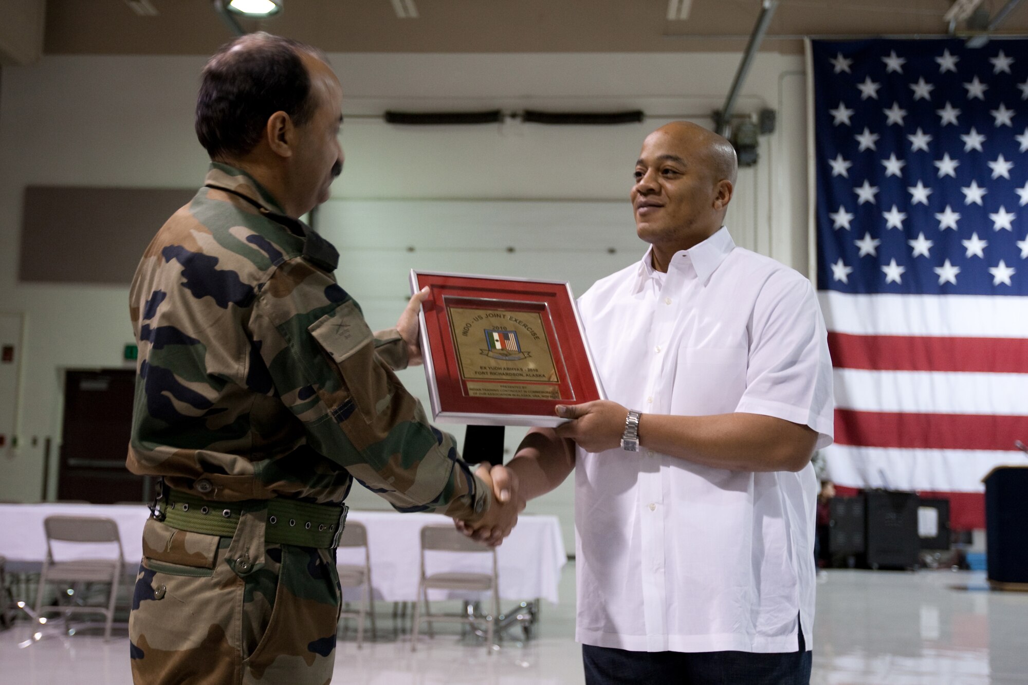 JOINT BASE ELMENDORF-RICHARDSON, Alaska - Brigadier Prem Mohan Vats, commander 62d Brigade Indian Army (left) presents a plaque to Army CW2 Kenneth Powell, in appreciation for the food service provided to his soldiers during the joint training. (U.S. Air Force Photo/Percy Jones)