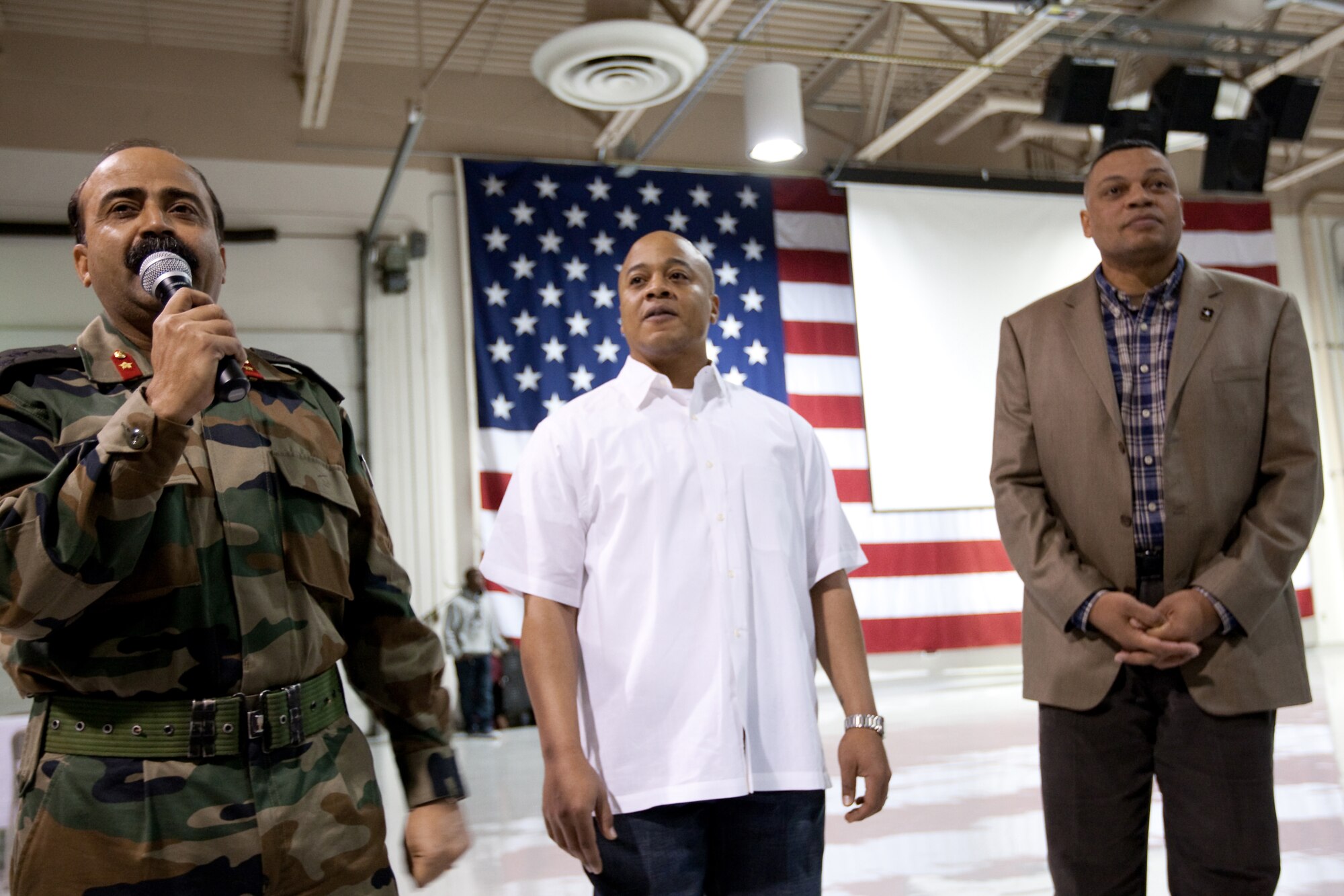 JOINT BASE ELMENDORF-RICHARDSON, Alaska - Army Col. Morris Goins (right), commander 4th Brigade Combat Team (Airborne), 25th Infantry Division, listens as Brigadier Prem Mohan Vats, Commander 62d Brigade Indian Army (left) addresses the audience before presenting at plaque to Army CW2 Kenneth Powell, Food Service Manager, Wilderness Inn Dining Facility, in appreciation for the food service provided to his soldiers during the joint training. (U.S. Air Force Photo/Percy Jones)