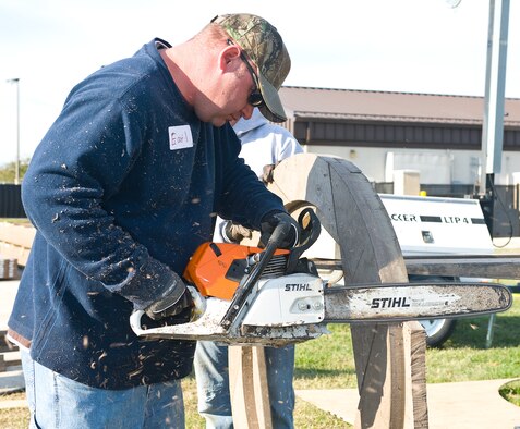 Base volunteers prepare wood for construction of a new playground being built next to the base swimming pool at Dover AFB, De., Nov. 8, 2010. Wing leadership directed a portion of funds obtained from winning the 2010 Air Mobility Command's Commander-in-Chief's Award for Installation Excellence for the park’s construction.  The playground, designed by Leathers and Associates, features swings, slides and other play areas contained inside a huge shell resembling a large cargo military aircraft. It could be a C-17 or a C-5, depending on how you look at it. The park is being built by more than 900 base volunteers. (U.S. Air Force Photo/Roland Balik)