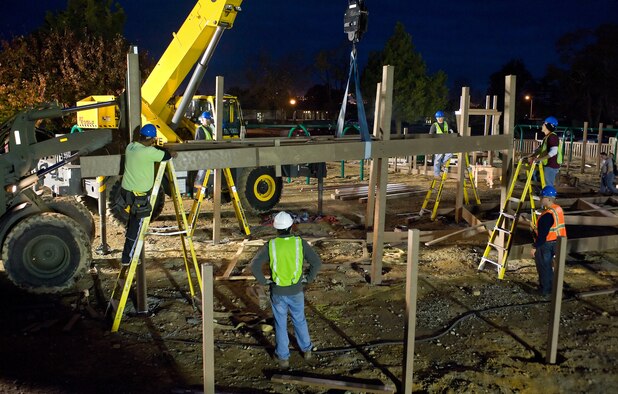 A section of the new playground is lifted into place for the new playground being constructed next to the base swimming pool at Dover AFB, De., Nov. 10, 2010. Wing leadership directed a portion of funds obtained from winning the 2010 Air Mobility Command's Commander-in-Chief's Award for Installation Excellence for the park’s construction. The playground, designed by Leathers and Associates, features swings, slides and other play areas contained inside a huge shell resembling a large cargo military aircraft. It could be a C-17 or a C-5, depending on how you look at it. The park is being built by more than 900 base volunteers. (U.S. Air Force Photo/Roland Balik)
