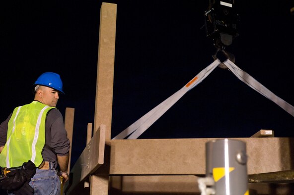 A section of the new playground is lifted into place for the new playground being constructed next to the base swimming pool at Dover AFB, De., Nov. 10, 2010. Wing leadership directed a portion of funds obtained from winning the 2010 Air Mobility Command's Commander-in-Chief's Award for Installation Excellence for the park’s construction.  The playground, designed by Leathers and Associates, features swings, slides and other play areas contained inside a huge shell resembling a large cargo military aircraft. It could be a C-17 or a C-5, depending on how you look at it. The park is being built by more than 900 base volunteers. (U.S. Air Force Photo/Roland Balik)