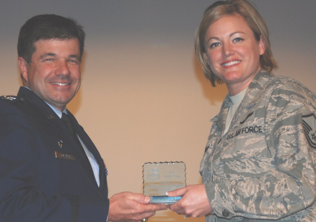 Scott Air Force Base, IL --- Master Sgt. Heather Braundmeier, receives the Senior NCO of the 4th Quarter award from Col. William Edwards, commander of the 932nd Airlift Wing.  Sergeant Braundmeier is  assigned to the 932nd Operations Support Flight,   Wing quarterly awards were announced at Commander's Call during the November unit training assembly.  (U.S. Air Force photo/Tech. Sgt. Dan Oliver) 