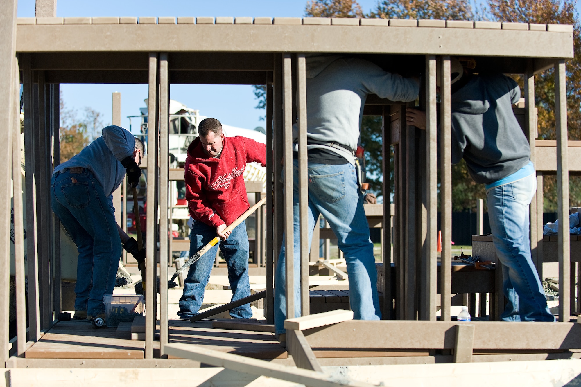 (UNRELEASED) Members of the 436th & 512th Airlift Wings work together to construct a playground at Eagle Park, Dover Air Force Base, Del., November 9. Organizers of the construction scheduled volunteers over a 5-day period to complete the construction of a play area resembling a C-5 aircraft, weather permitting. (U.S. Air Force photo/Roland Balik)