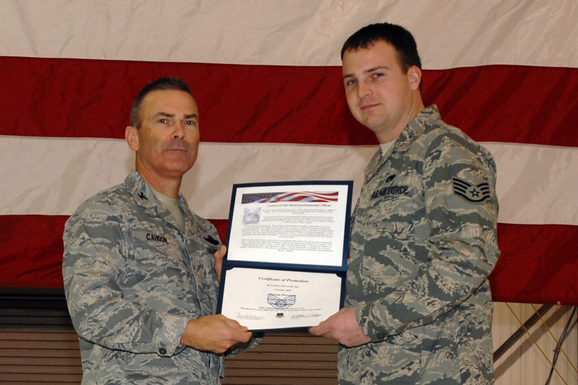 GRISSOM AIR RESERVE BASE, Ind. -- Col. William T. "Tim" Cahoon presents Staff Sgt. Aaron Preston with a certificate of promotion as he is inducted into the noncommissioned officer ranks during the November unit training assembly. Sergeant Preston is a KC-135R Stratotanker crew chief with the 434th Aircraft Maintenance Squadron. Colonel Cahoon is the 434th Air Refueling Wing commander. (U.S. Air Force photo/Senior Airman Carl Berry)
