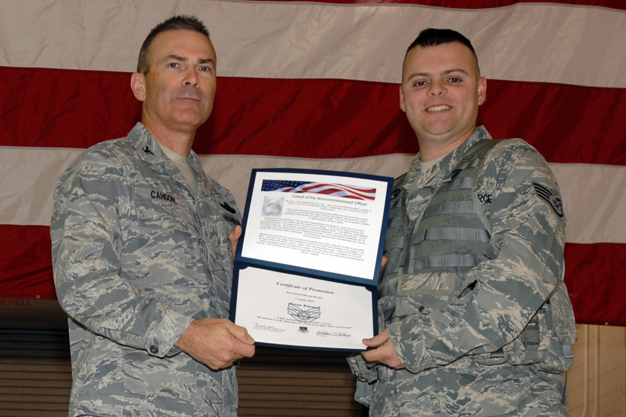 GRISSOM AIR RESERVE BASE, Ind. -- Col. William T. "Tim" Cahoon presents Staff Sgt. Javan Kimmel with a certificate of promotion as he is inducted into the noncommissioned officer ranks during the November unit training assembly. Sergeant Kimmel is a security forces team member with the 434th Security Forces Squadron. Colonel Cahoon is the 434th Air Refueling Wing commander. (U.S. Air Force photo/Senior Airman Carl Berry)
