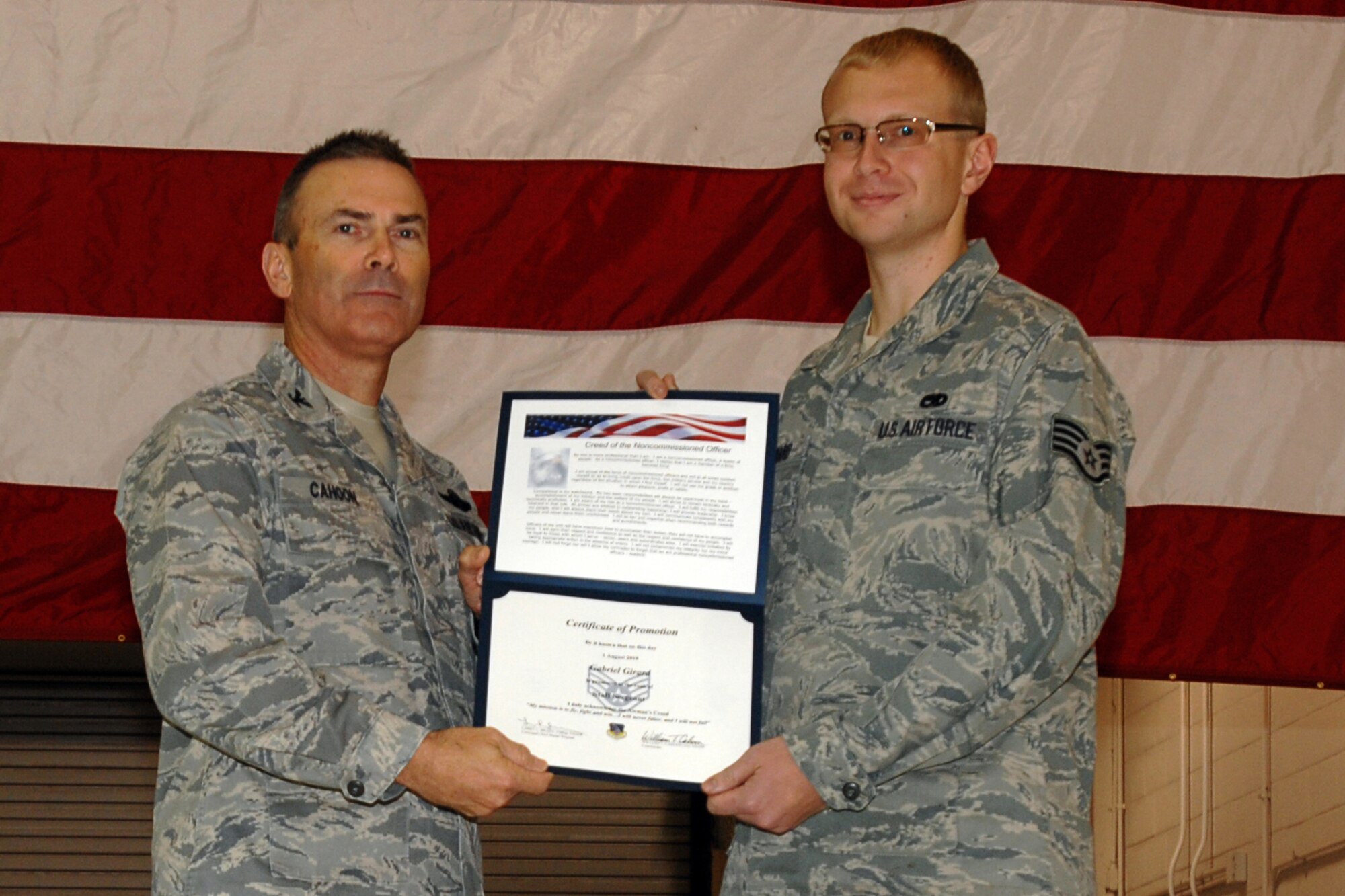 GRISSOM AIR RESERVE BASE, Ind. -- Col. William T. "Tim" Cahoon presents Staff Sgt. Gabriel Girard with a certificate of promotion as he is inducted into the noncommissioned officer ranks during the November unit training assembly. Sergeant Girard is a KC-135R Stratotanker crew chief with the 434th Aircraft Maintenance Squadron. Colonel Cahoon is the 434th Air Refueling Wing commander. (U.S. Air Force photo/Senior Airman Carl Berry)

