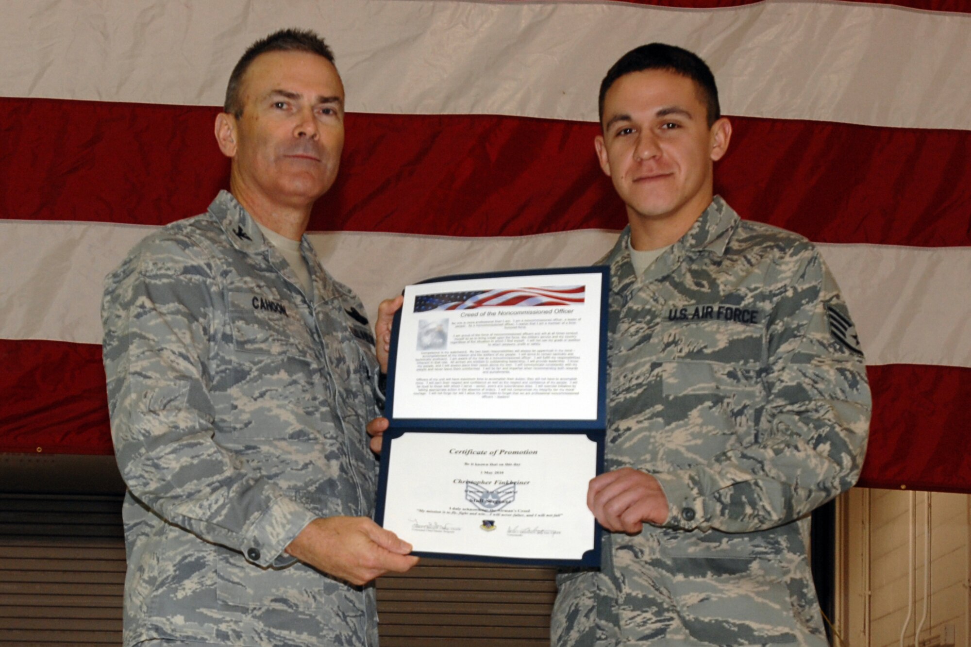 GRISSOM AIR RESERVE BASE, Ind. -- Staff Sgt. Christopher Finkbeiner is presented with a certificate of promotion by Col. William T. "Tim" Cahoon during a special induction ceremony held here during the November unit training assembly. Sergeant Finkbeiner, a vehicle maintenance specialist with the 434th Logistics Readiness Squadron, along with 18 other Grissom Airmen inducted into the noncommissioned officer ranks. Colonel Cahoon is the 434th Air Refueling Wing commander. (U.S. Air Force photo/Senior Airman Carl Berry)
