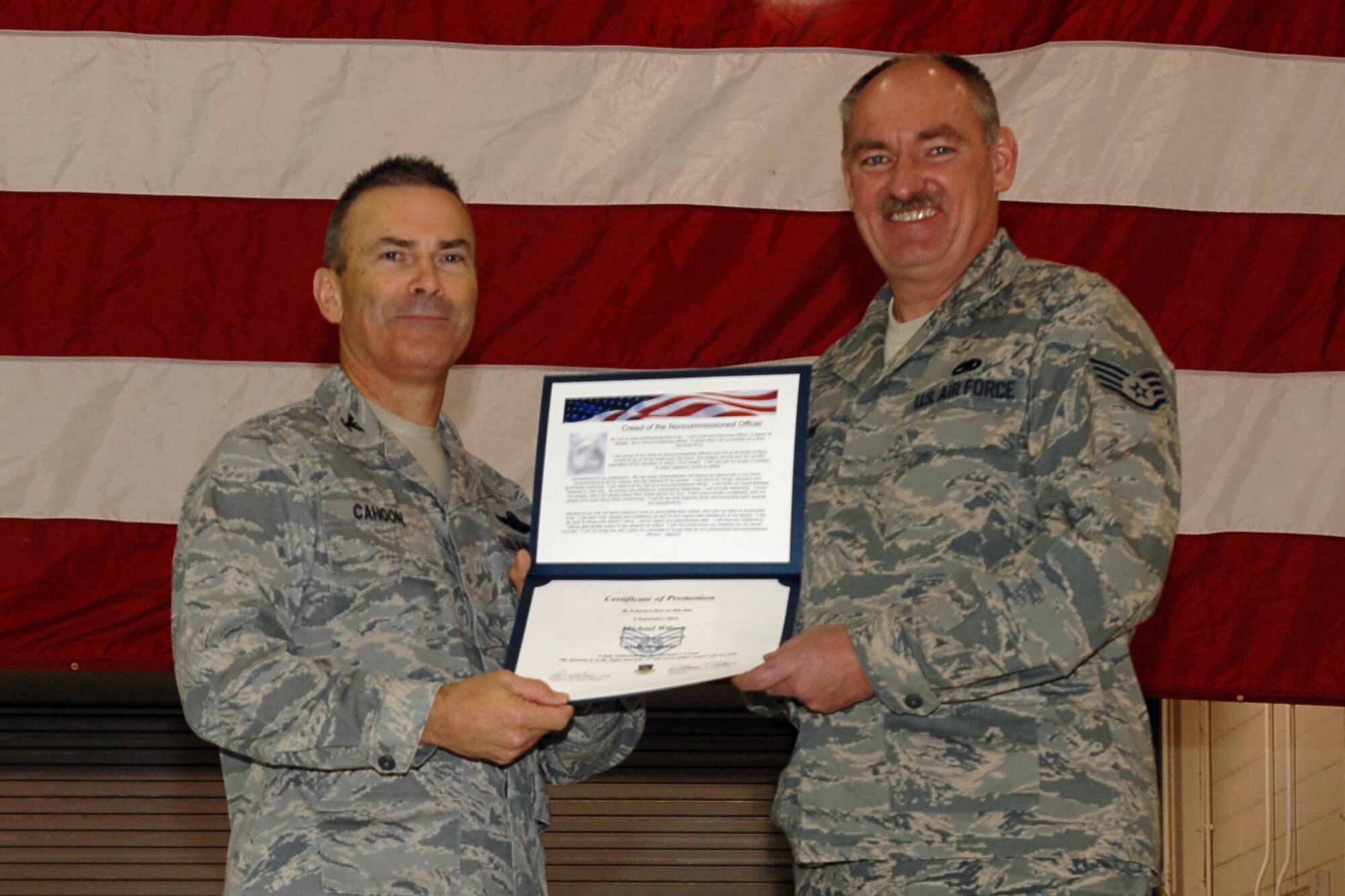 GRISSOM AIR RESERVE BASE, Ind. -- Col. William T. "Tim" Cahoon presents Staff Sgt. Michael Wilson with a certificate of promotion as he is inducted into the noncommissioned officer ranks during the November unit training assembly. Sergeant Wilson is a KC-135R Stratotanker crew chief with the 434th Aircraft Maintenance Squadron. Colonel Cahoon is the 434th Air Refueling Wing commander. (U.S. Air Force photo/Senior Airman Carl Berry)
