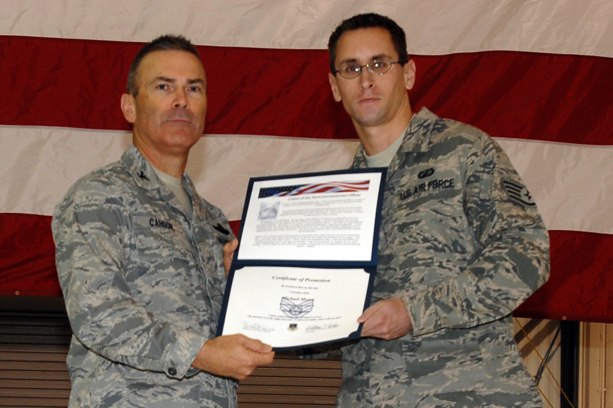 GRISSOM AIR RESERVE BASE, Ind. -- Col. William T. "Tim" Cahoon and Staff Sgt. Michael Meyer pose for a photo as Sergeant Meyer is inducted into the ranks of noncommissioned officers during a special ceremony held here during the November unit training assembly. Sergeant Meyer, a financial management specialist with the 434th Air Refueling Wing, along with 18 other Grissom Airmen, was recognized for their promotions to staff sergeant during the ceremony. Colonel Cahoon is the 434th ARW commander. (U.S. Air Force photo/Senior Airman Carl Berry)
