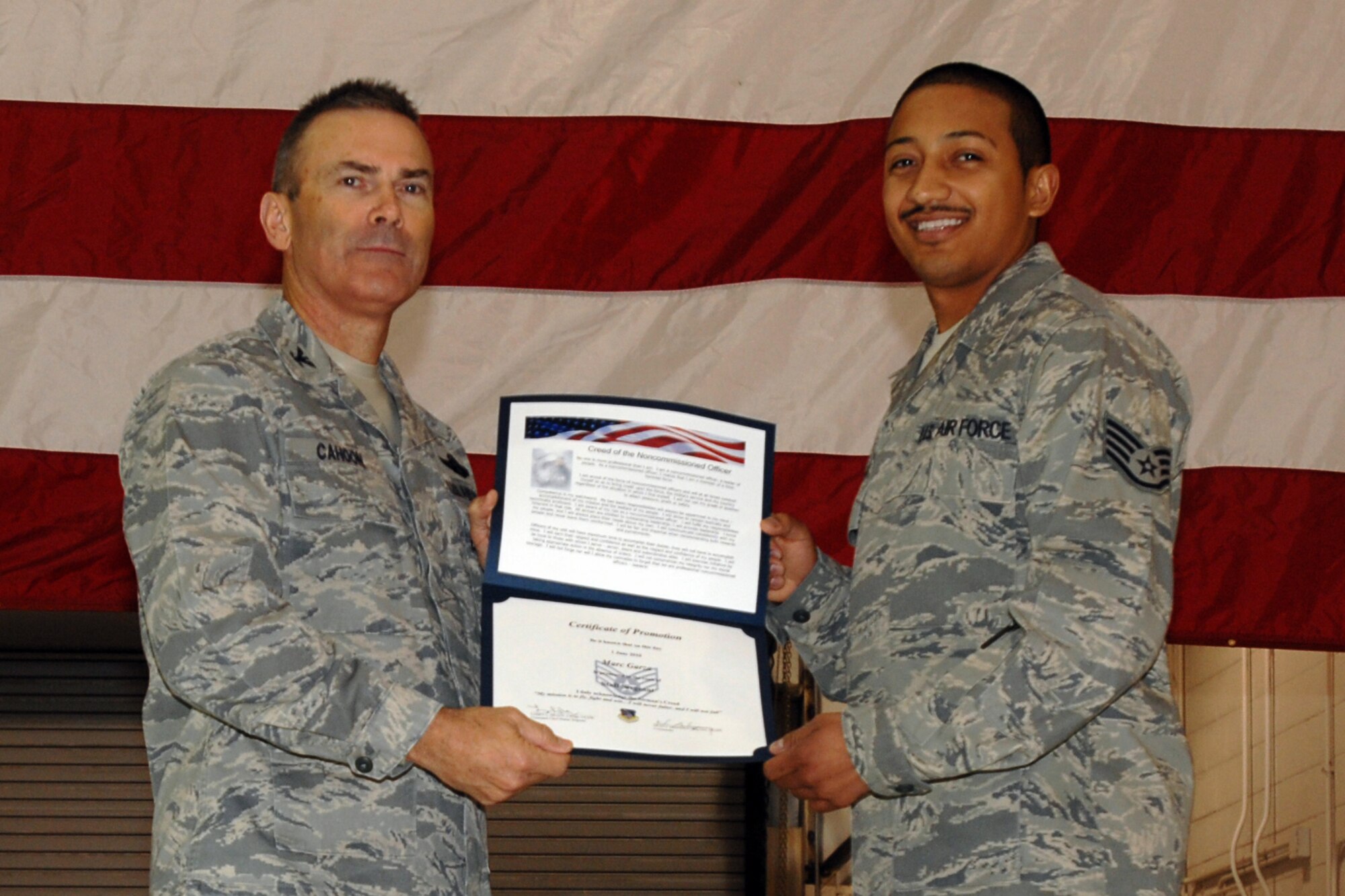GRISSOM AIR RESERVE BASE, Ind. -- Staff Sgt. Marc Garza is presented with a certificate of promotion by Col. William T. "Tim" Cahoon during a special induction ceremony held here during the November unit training assembly. Sergeant Garza, a cyber transport sytems specialist with the 434th Communications Squadron, along with 18 other Grissom Airmen inducted into the noncommissioned officer ranks. Colonel Cahoon is the 434th Air Refueling Wing commander. (U.S. Air Force photo/Senior Airman Carl Berry)
