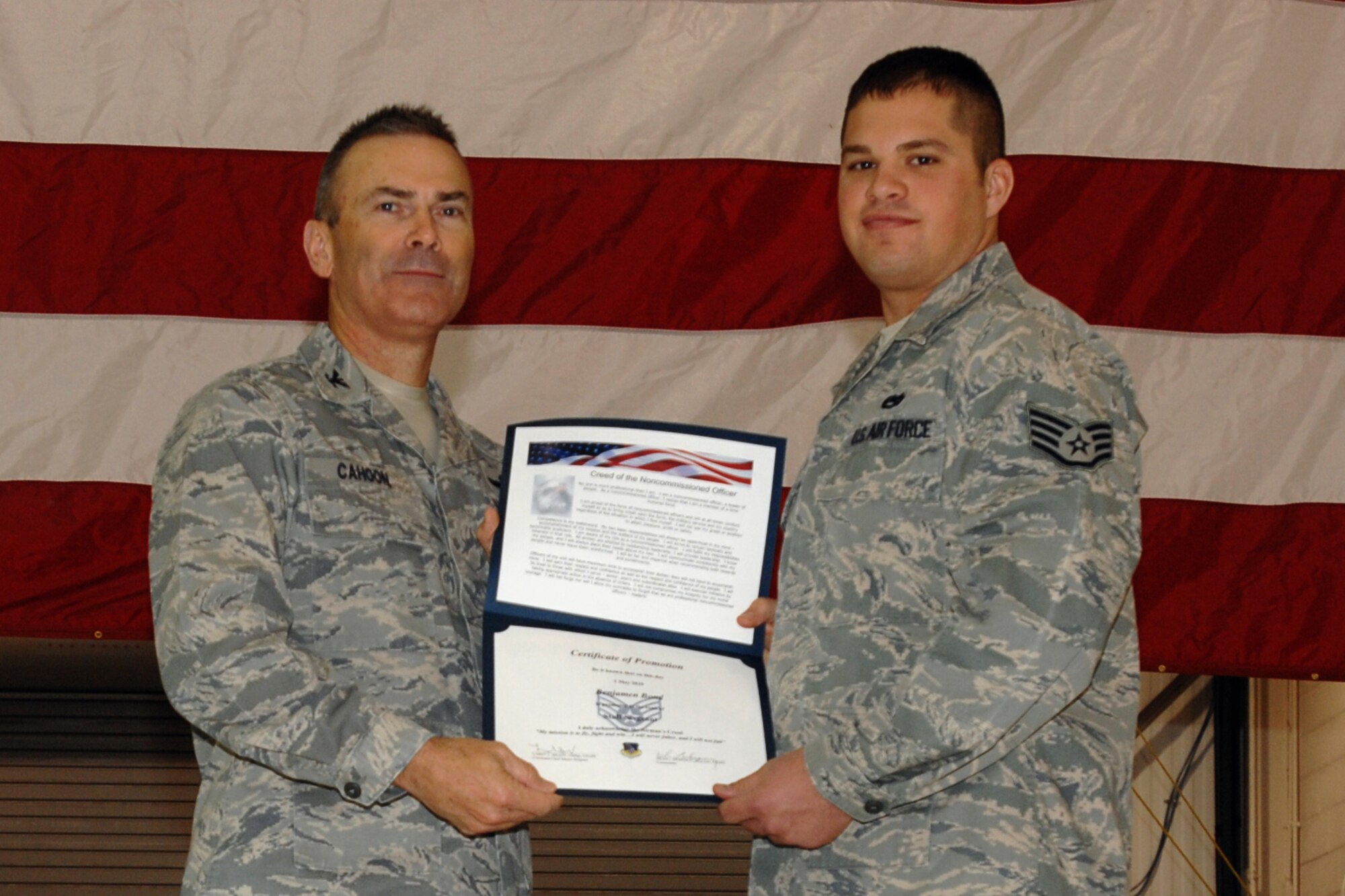GRISSOM AIR RESERVE BASE, Ind. -- Col. William T. "Tim" Cahoon presents Staff Sgt. Benjamen Bond with a certificate of promotion as he is inducted into the noncommissioned officer ranks during the November unit training assembly. Sergeant Bond is a KC-135R Stratotanker crew chief with the 434th Aircraft Maintenance Squadron. Colonel Cahoon is the 434th Air Refueling Wing commander. (U.S. Air Force photo/Senior Airman Carl Berry)
