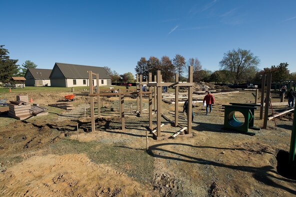 A new playground, being built next to the base swimming pool, takes shape on day two of construction at Dover AFB, De., Nov. 7, 2010. Wing leadership directed a portion of funds obtained from winning the 2010 Air Mobility Command's Commander-in-Chief's Award for Installation Excellence for the park’s construction.  The playground, designed by Leathers and Associates, features swings, slides and other play areas contained inside a huge shell resembling a large cargo military aircraft. It could be a C-17 or a C-5, depending on how you look at it. The park is being built by more than 900 base volunteers. (U.S. Air Force Photo/Jason Minto)