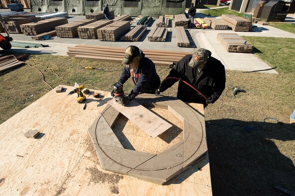 Base volunteers prepare wood for construction of a new playground being built next to the base swimming pool at Dover AFB, De., Nov. 7, 2010. Wing leadership directed a portion of funds obtained from winning the 2010 Air Mobility Command's Commander-in-Chief's Award for Installation Excellence for the park’s construction.  The playground, designed by Leathers and Associates, features swings, slides and other play areas contained inside a huge shell resembling a large cargo military aircraft. It could be a C-17 or a C-5, depending on how you look at it. The park is being built by more than 900 base volunteers. (U.S. Air Force Photo/Jason Minto)