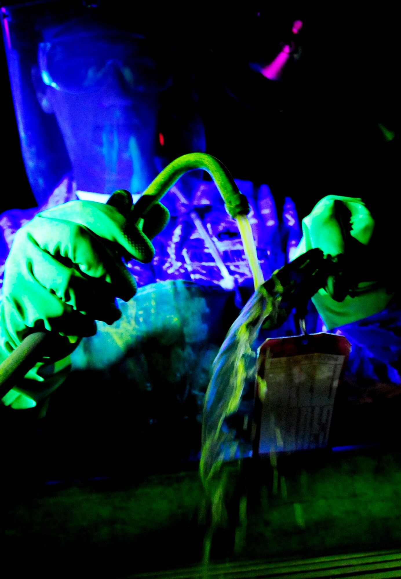 RAF MILDENHALL, England -- Staff Sgt. Frank Castonguay, 100th Maintenance Squadron non destructive craftsman, sprays a florescent magnetic bath on a KC-135 Stratotanker up-lock bracket during a magnetic particle inspection Nov. 16, 2010. The KC-135 up-lock bracket is sprayed under a black light and magnetized so that any cracks can be identified. (U.S. Air Force photo/Senior Airman Ethan Morgan)