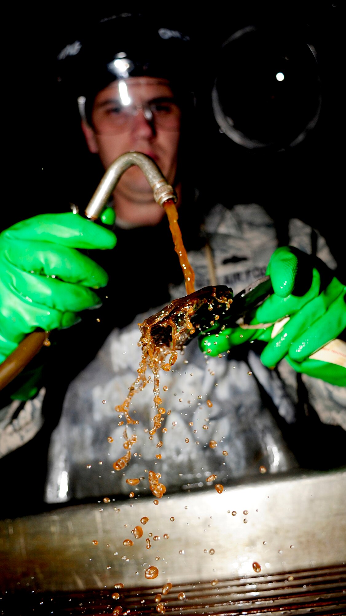 RAF MILDENHALL, England -- Staff Sgt. Frank Castonguay, 100th Maintenance Squadron non destructive craftsman, sprays a florescent magnetic bath on a KC-135 Stratotanker up-lock bracket during a magnetic particle inspection Nov. 16, 2010. The bath is used to fill any cracks in a suspected damaged piece of equipment which will then glow under a black light to determine whether it?s damaged. (U.S. Air Force photo/Senior Airman Ethan Morgan)