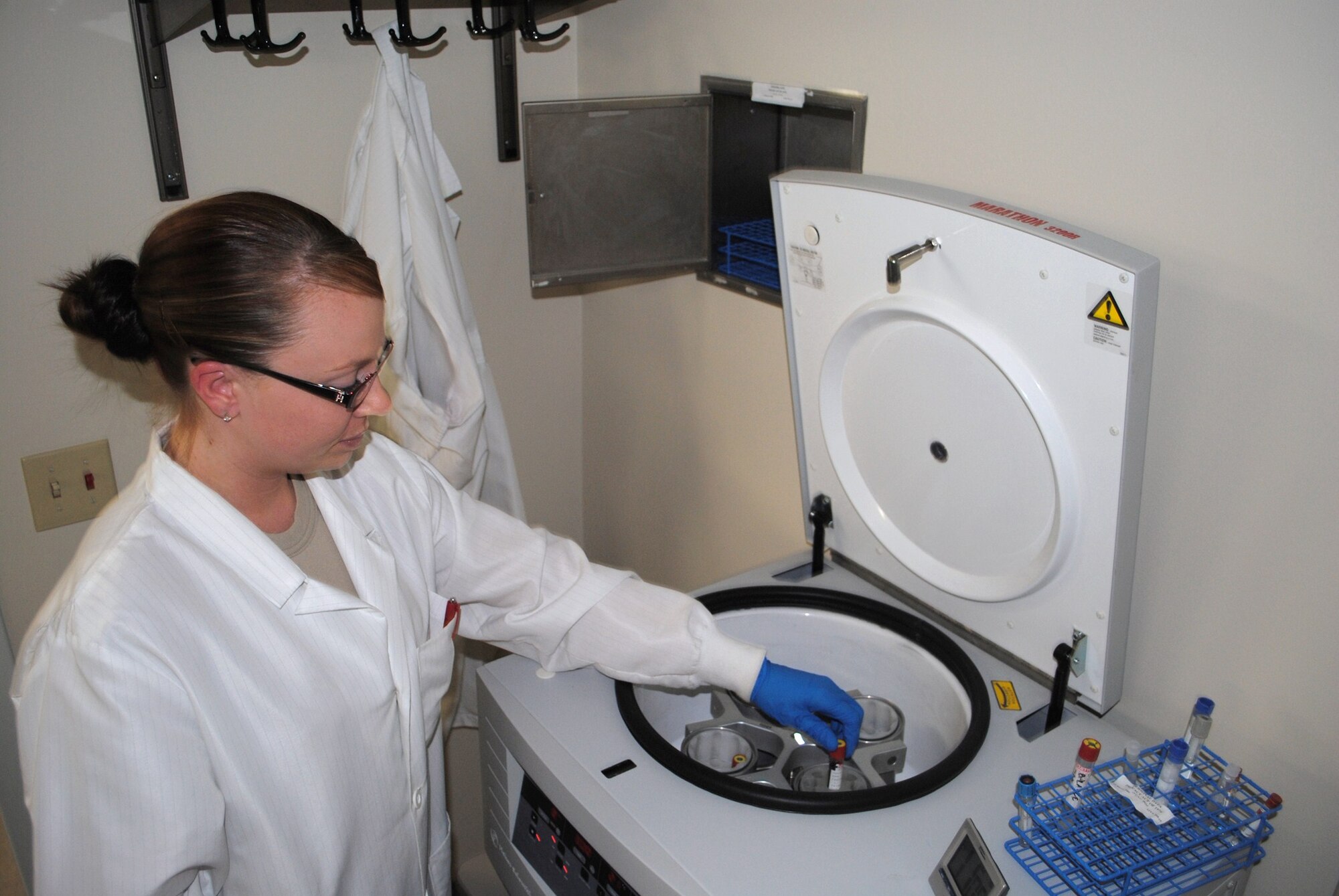 Senior Airman Leslie Balliew, 341st Medical Group clinical laboratory technician, places a blood sample in a centrifuge Nov. 11. Laboratory centrifuges are used for isolating and separating solids from liquids in suspension.  (U.S. Air Force photo/Airman 1st Class Kristina Overton)