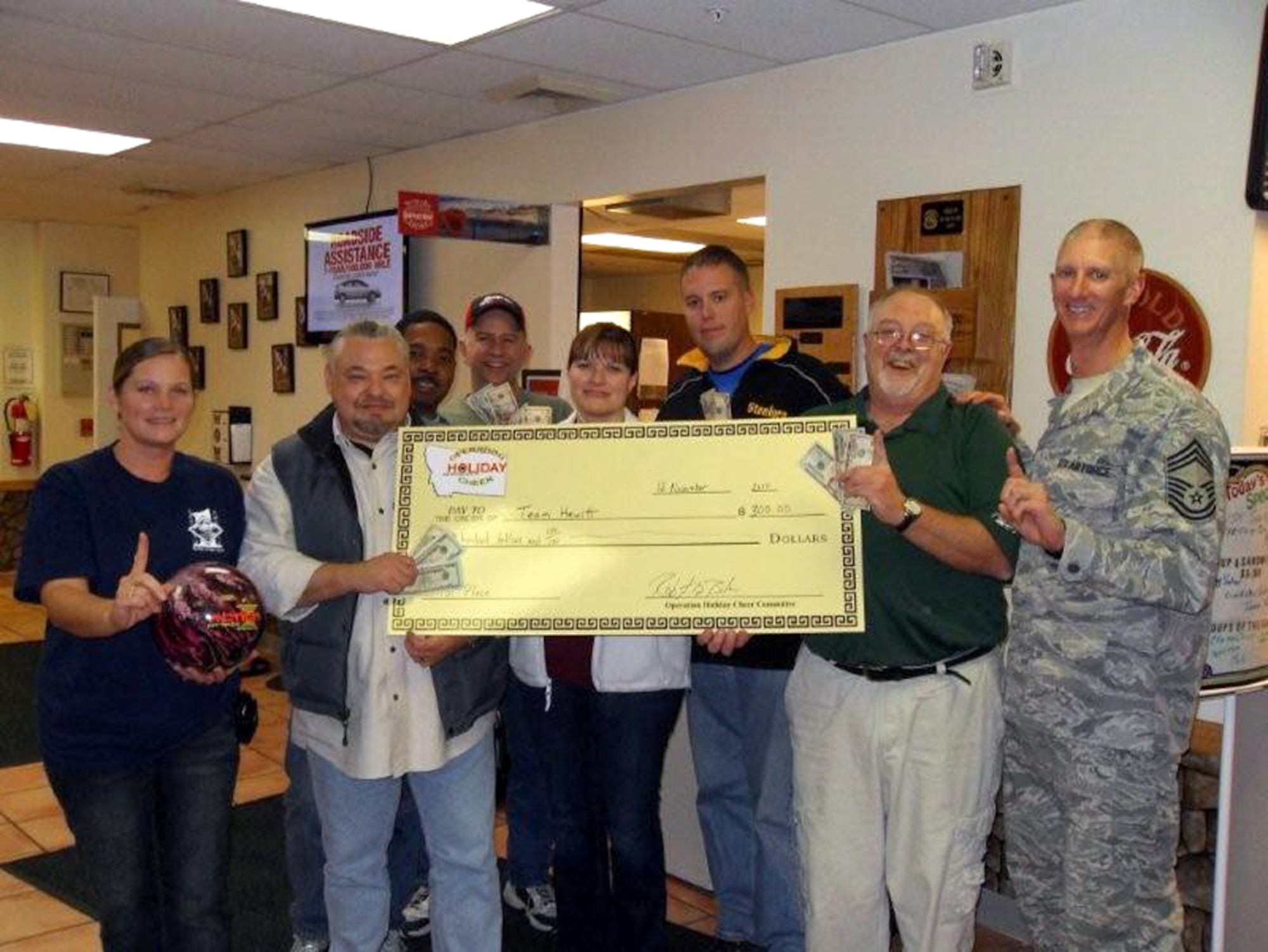 "Team Hewitt" took home the $300 first-place prize in the Operation Happy Holidays No-Tap Tournament Nov. 12. Pictured from left to right are first sergeant Master Sgt. Shiela Lawson, this year's OHH organizer; team members Mark Hewitt, Master Sgt. Jesse West, Dwight Pearch, Tech. Sgt. Tracey Halman, Senior Airman Timothy Warden and Wayne Quinby. Chief Master Sgt. Craig Fitzkee was aslo on hand representing the 341st Missile Wing command chief. (Courtesy photo)