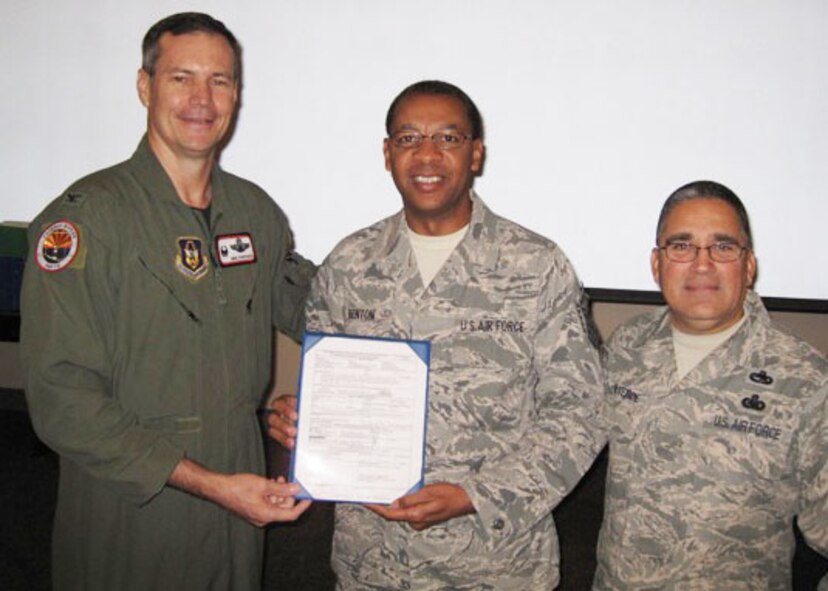 Master Sgt. Melvin Benton, 919th Logistics Readiness Squadron, (center)  proudly displays the official order that recently promoted him to the rank of master sergeant.  While away on a temporary duty assignment at Luke Air Force Base, Ariz., the Duke Field reservist received his new stripes in a surprise presentation by Col. Michael Popovich, 944th Fighter Wing commander (left) and Chief Master Sgt. Pablo Valverde, 944th FW command chief. Sergeant Benton was one of eight Duke Field reservists awarded immediate, on-the-spot Promotion Enhancement Program promotions during the wing’s October unit training assembly. The PEP is a commander’s program designed to promote outstanding and well-deserving Air Force Reserve Airmen one grade above the authorized grade for their position. Only those Airmen who show outstanding potential are considered based on a demonstrated ability to serve in the next higher grade. (Courtesy photo)
