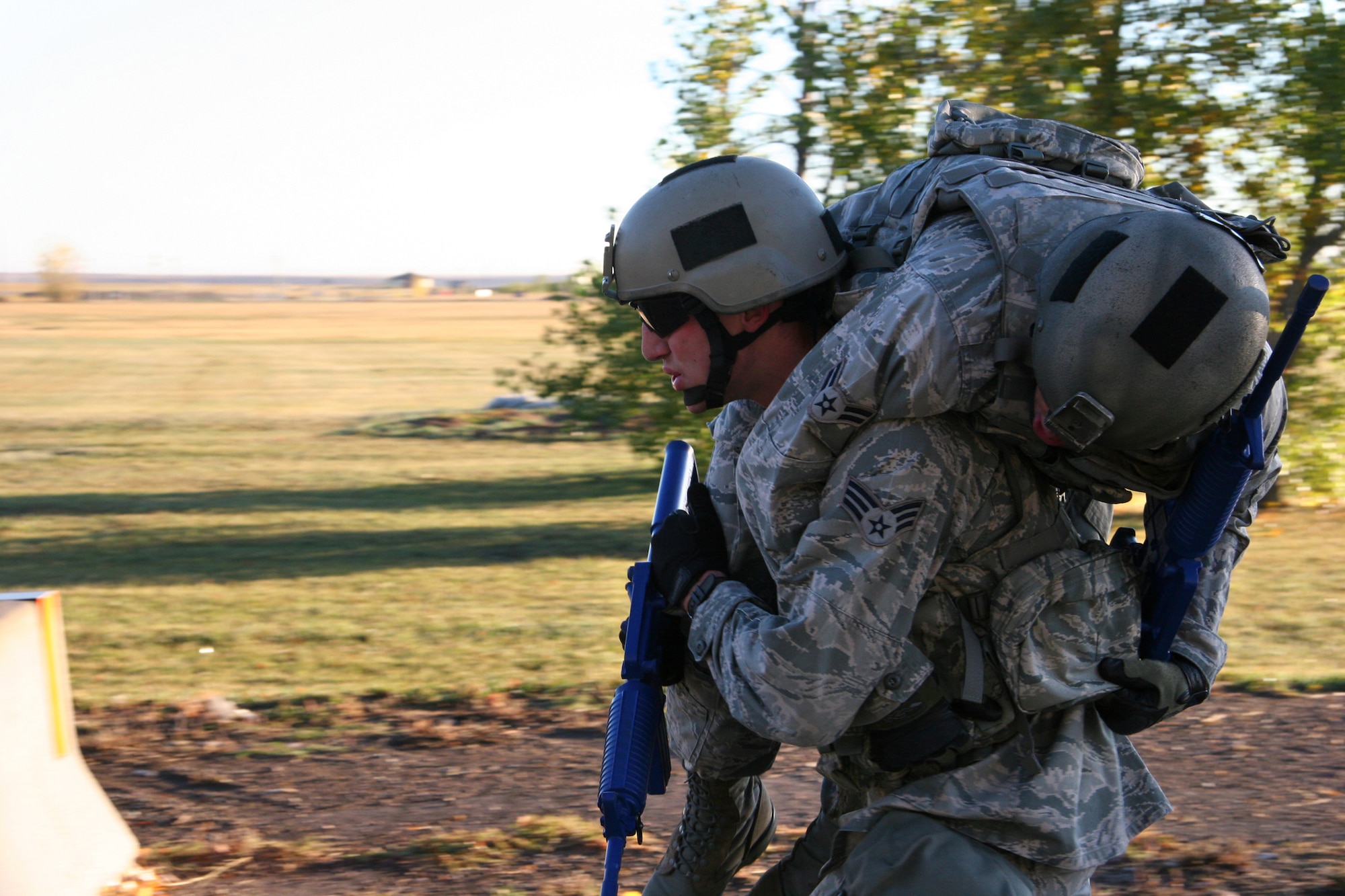Senior Airman Dustin Taylor, 341st Security Forces Squadron Tactical Response Force member, carries Airman 1st Class Alan Crawford, also from TRF, Oct. 6 near the Warrior Launch Facility trainer during preperation for the 2010 Global Strike Challenge competition. (U.S. Air Force photo/Staff Sgt. Dillon White) 