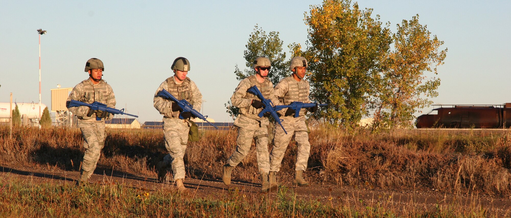 From left, Airman 1st Class Alan Crawford, 1st Lt. William Glojek, Senior Airman Dustin Taylor and Airman 1st Class Michael Travis run near the Warrior Launch Facility trainer to prepare for competition in the 2010 Global Strike Challenge competition. Lieutenant Glojek is the officer in charge of the 741st Missile Security Forces Squadron Convoy Response Force. Airmen Crawford, Taylor and Travis are all members of the 341st Security Forces Squadron Tactical Response Force. Each Defender was hand-selected to represent Malmstrom during this years competition. (U.S. Air Force photo/Staff Sgt. Dillon White)