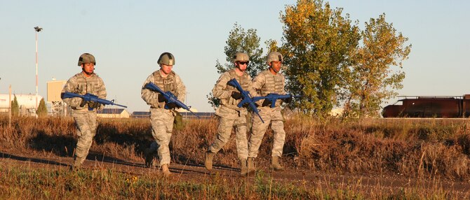 From left, Airman 1st Class Alan Crawford, 1st Lt. William Glojek, Senior Airman Dustin Taylor and Airman 1st Class Michael Travis run near the Warrior Launch Facility trainer to prepare for competition in the 2010 Global Strike Challenge competition. Lieutenant Glojek is the officer in charge of the 741st Missile Security Forces Squadron Convoy Response Force. Airmen Crawford, Taylor and Travis are all members of the 341st Security Forces Squadron Tactical Response Force. Each Defender was hand-selected to represent Malmstrom during this years competition. (U.S. Air Force photo/Staff Sgt. Dillon White)