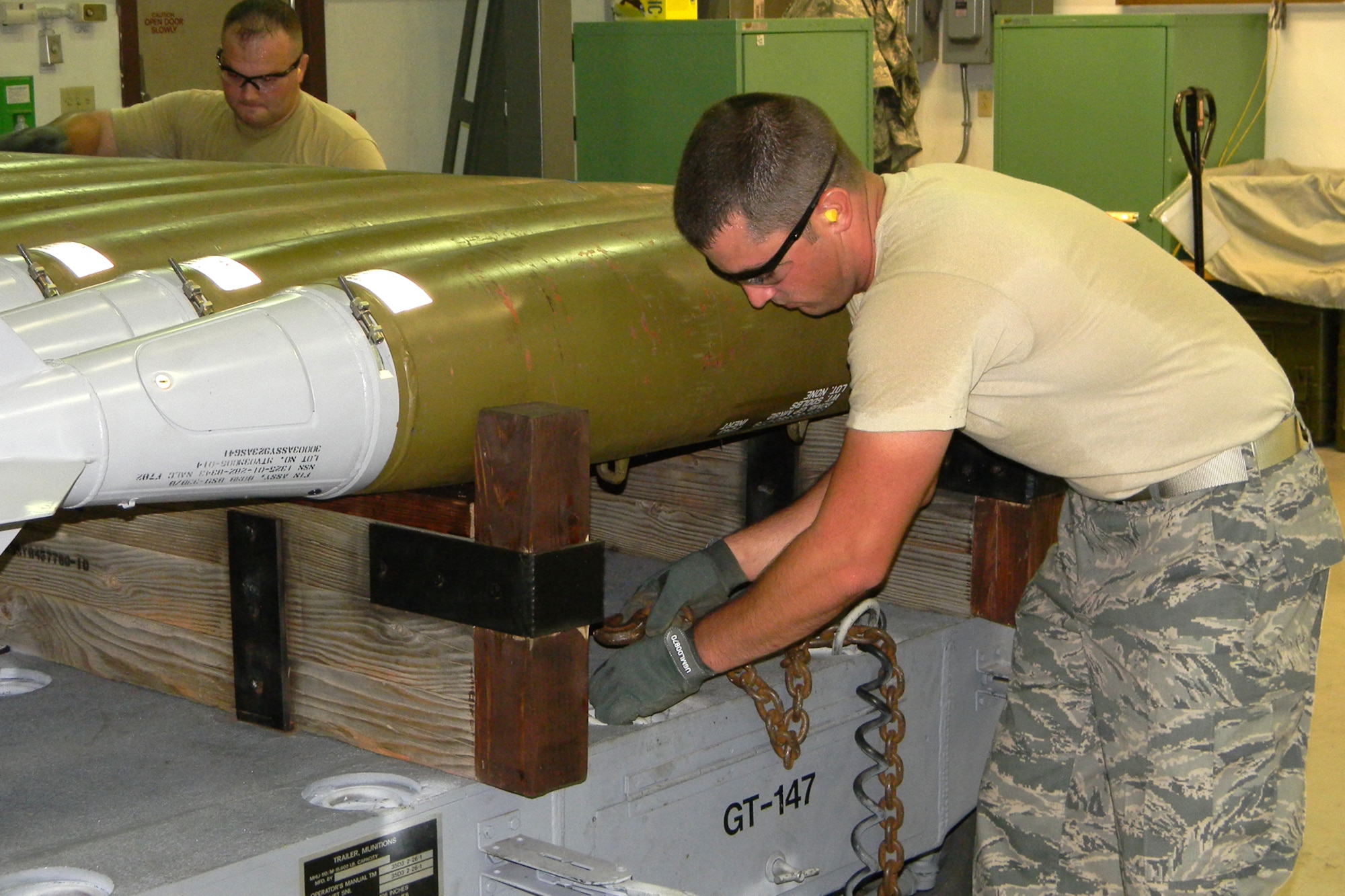 Staff Sgt. Ryan Meaux secures the chain to tie down the 12ea MK82 low drag inert
bombs to the Railed MHU-110 Trailer, during competition in the first-ever Global Strike Challenge at Barksdale Air Force Base, La., Aug. 18, 2010. However, the 917th Wing team was unique in that it was totally integrated with Traditional Reservists, Air Reserve Technicians and Regular Air Force Airmen, who work side-by-side on a regular basis as integral parts of the 917th Wing team effort. (U.S. Air Force photo/Senior Master Sgt. Joel Estes) 
