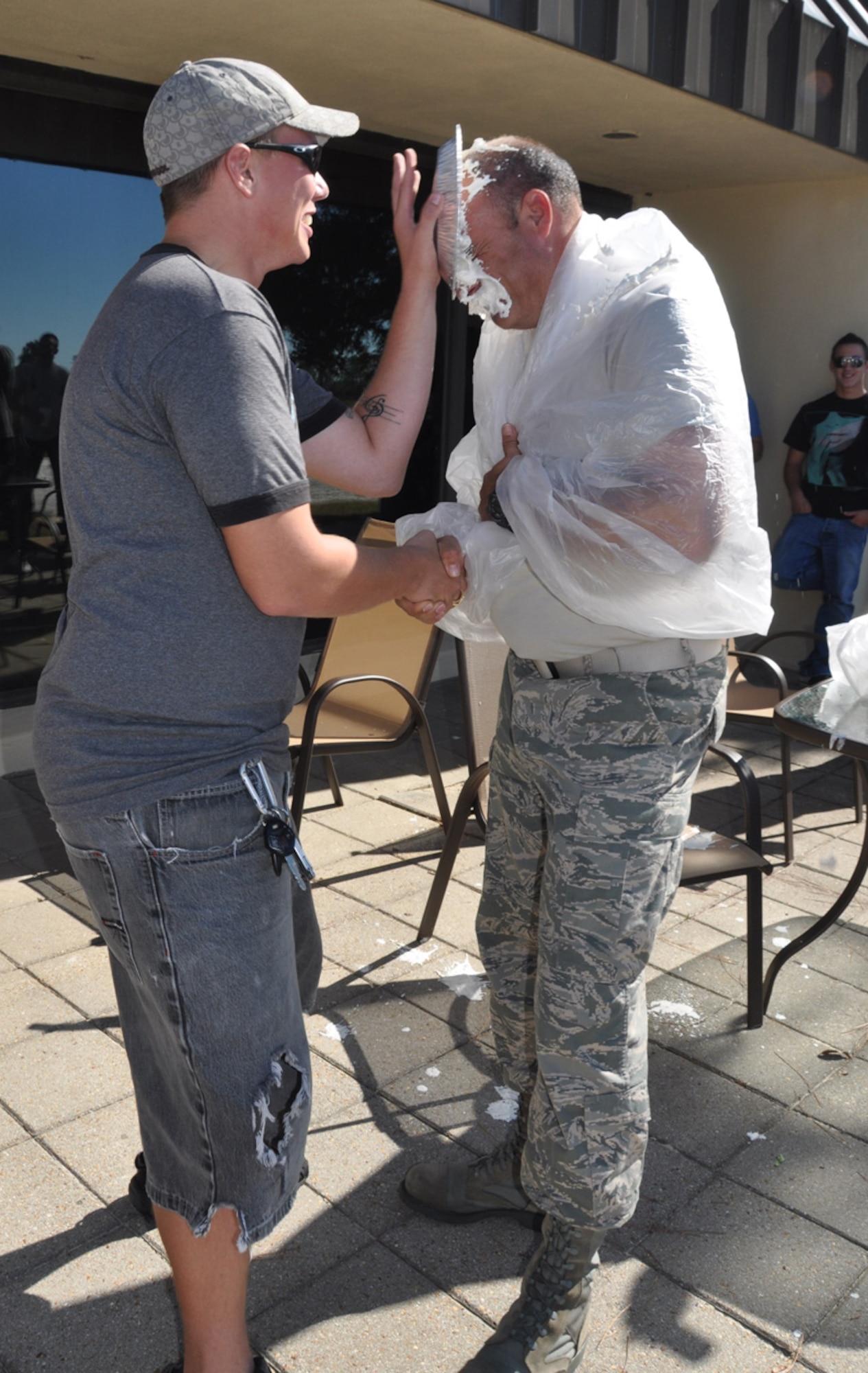 Airman 1st Class Zachery Seymour, 325th Maintenance Squadron F-15 avionics technician, "pies" Master Sgt. Michael Hair, 325th MXS first sergeant, in the face Nov. 12 during the dorm cleanup pizza party. (U.S. Air Force photo by Airman 1st Class Rachelle Elsea)