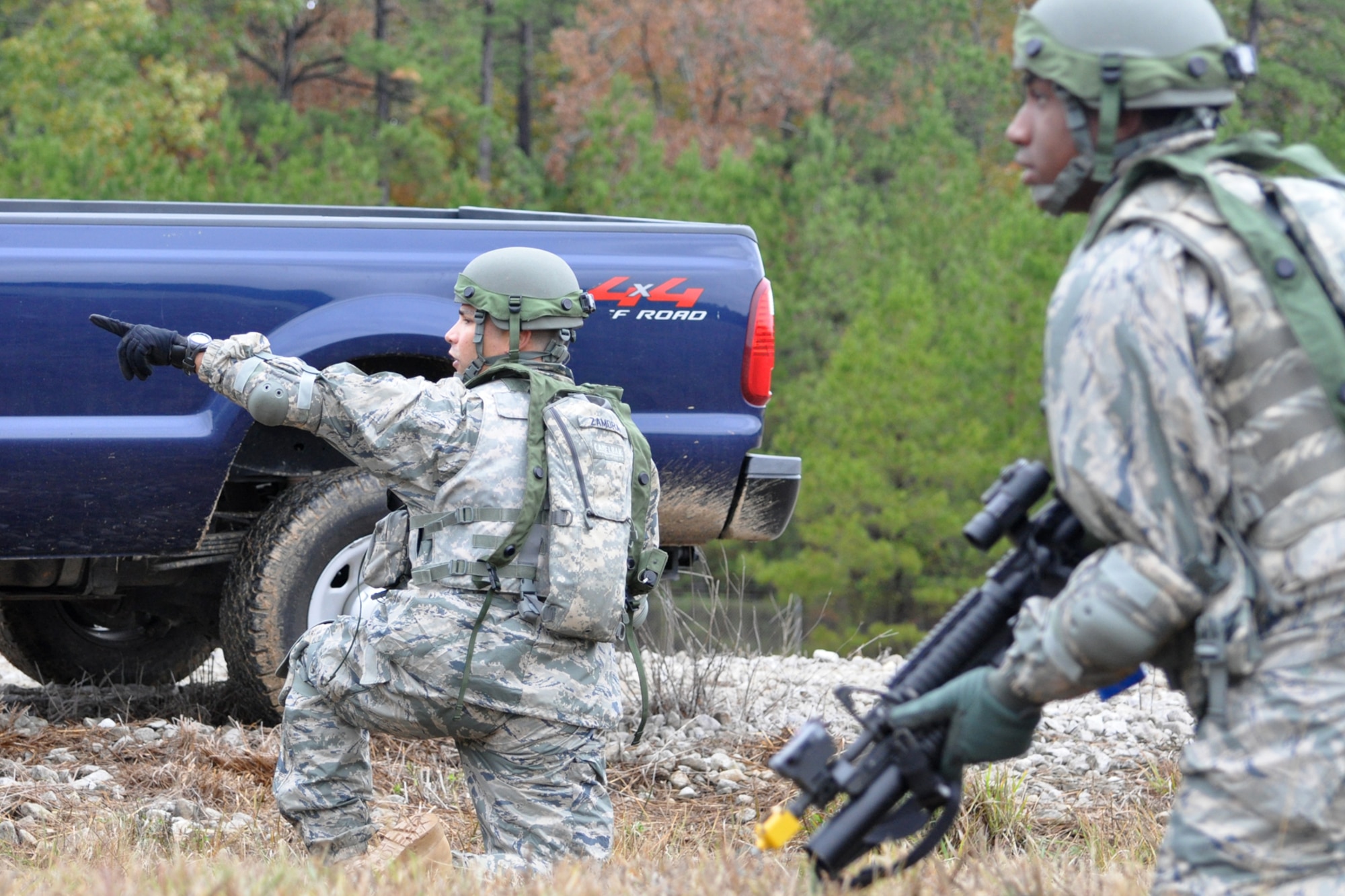 Technical Sgt. Daniel Zamora, team leader for the 917th Security Forces Squadron tactics team, directs Airman First Class Trevor Forman where to focus his attention after a firefight with aggressor forces during the Firing and Tactics Event at Camp Minden in Louisiana, Nov. 13, 2010. The event was part of the first-ever Global Strike Challenge, which wrapped up at Barksdale Air Force Base, La., Nov. 17, 2010. A six-man team from the 917th SFS competed in the event against other teams from numerous bases involved in the competition. The Multiple Integrated Laser Engagement System or MILES, which uses lasers and blank cartridges to simulate actual battle, was used for the event to identify the Airmen who were killed. This system is used by the U.S. military and other armed forces around the world for training purposes. (U.S. Air Force photo/Tech. Sgt. Jeff Walston)