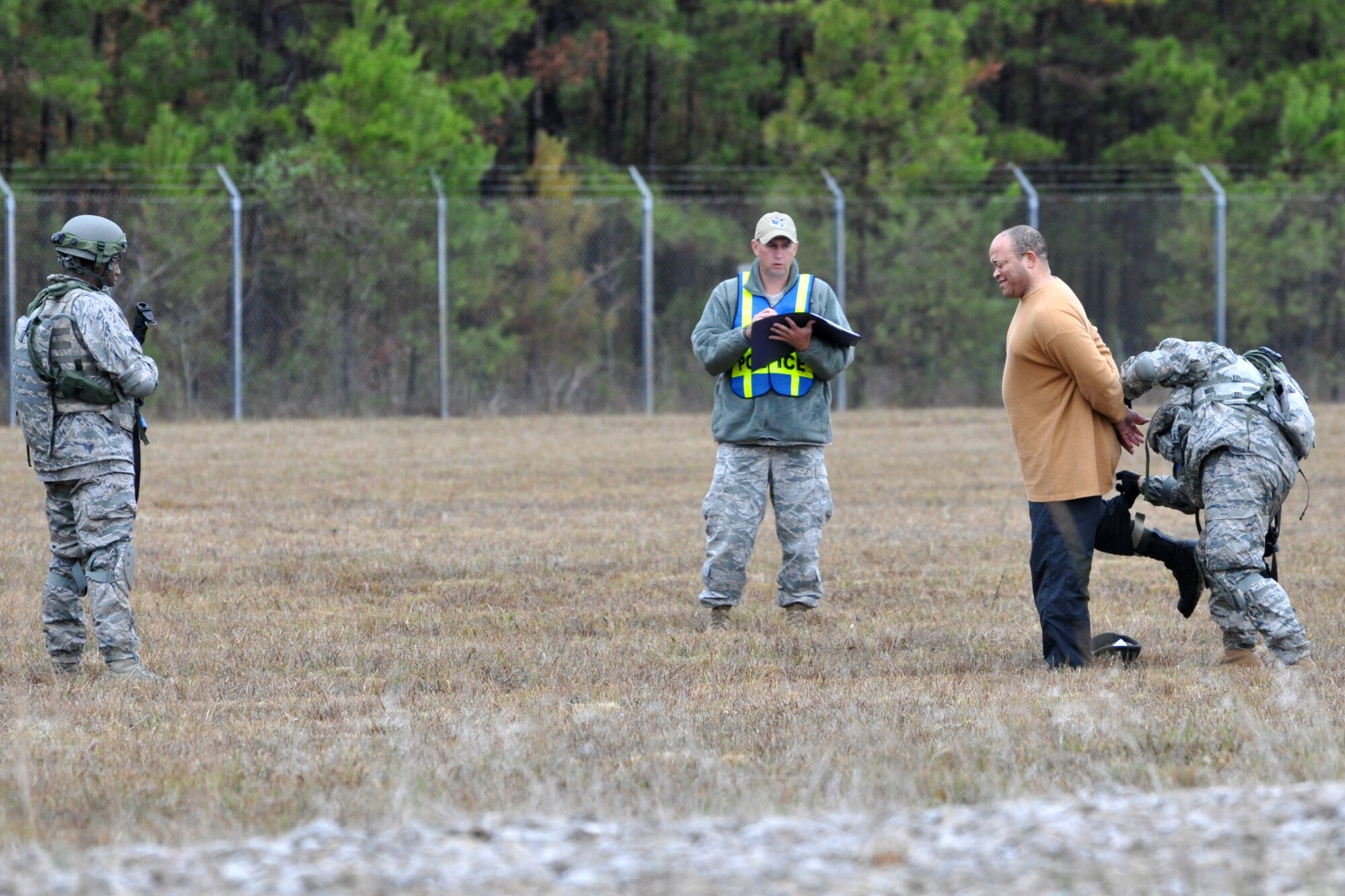 Airman First Class Trevor Forman covers Technical Sgt. Daniel Zamora as he searches a man (actor) who strays into a secure area during the Firing and Tactics Event at Camp Minden in Louisiana, Nov. 13, 2010. The event was part of the first-ever Global Strike Challenge, which wrapped up at Barksdale Air Force Base, La., Nov. 17, 2010. A six-man team from the 917th SFS competed in the event against other teams from numerous bases involved in the competition. Every move and response was being judged and scored by officials for a final tally, which will determine the winners of the event. (U.S. Air Force photo/Tech. Sgt. Jeff Walston)