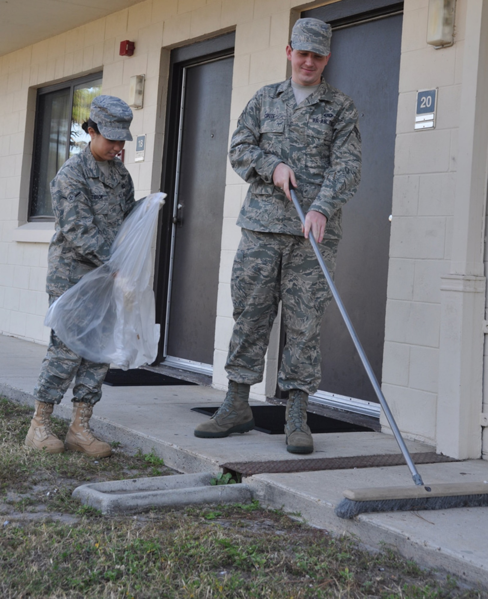 Airman Nikki Stibick and Airman 1st Class Paul Crute, 325th Air Control Squadron pilot simulator technicians, participate in the Tyndall dorm cleanup Nov. 12. (U.S. Air Force photo by Airman 1st Class Rachelle Elsea)