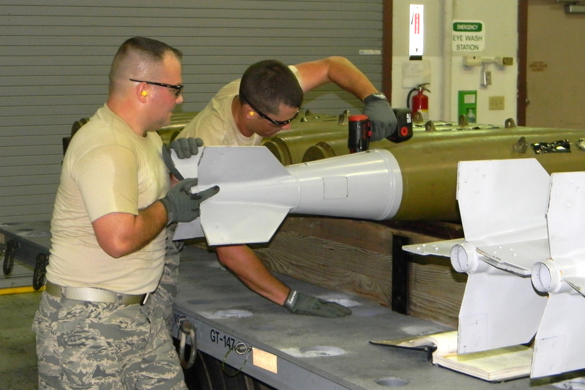 Technical Sgt. Christopher Ballard, a 917th Wing Air Reserve Technician, holds a BSU-33 fin as Staff Sgt. Ryan Meaux tightens the fin down to MK82 inert bomb during competition in the first-ever Global Strike Challenge at Barksdale Air Force Base, La., Aug. 18, 2010. More than 400 Airmen from many bases competed in the competition. However, the 917th Wing team was unique in that it was totally integrated with Traditional Reservists, Air Reserve Technicians and Regular Air Force Airmen, who work side-by-side on a regular basis as integral parts of the 917th Wing team effort. Staff Sgt. Meaux is a Traditional Reservist with the 917th Wing. (U.S. Air Force photo/Senior Master Sgt. Joel Estes) 
