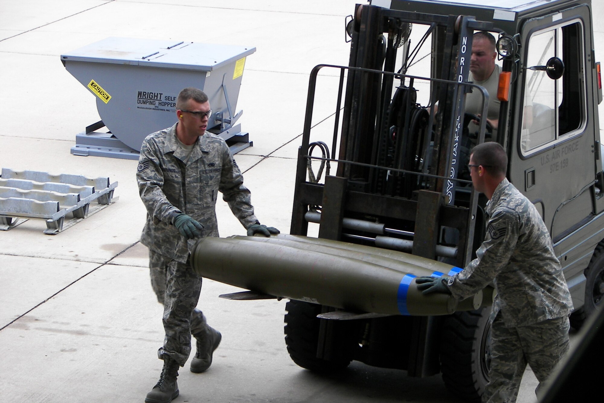 Staff Sergeants Howard Jennings and Ryan Meaux stabilize three inert MK82 bomb bodies on a forklift driven by Technical Sgt. Christopher Ballard during the first-ever Global Strike Challenge at Barksdale Air Force Base, La., Aug. 18, 2010. More than 400 Airmen from many bases competed in the competition on August 17-18. However, the 917th Wing team was unique in that it was totally integrated with Regular Air Force Airmen, Reservists and Air Reserve Technicians who work side-by-side on a regular basis as integral parts of the 917th Wing team effort. (Staff Sgt. Meaux - Traditional Reservist, Staff Sgt. Jennings – Regular Air Force, Tech. Sgt. Ballard – Air Reserve Technician) (U.S. Air Force photo/Staff Sgt. Michael O’Rourke)